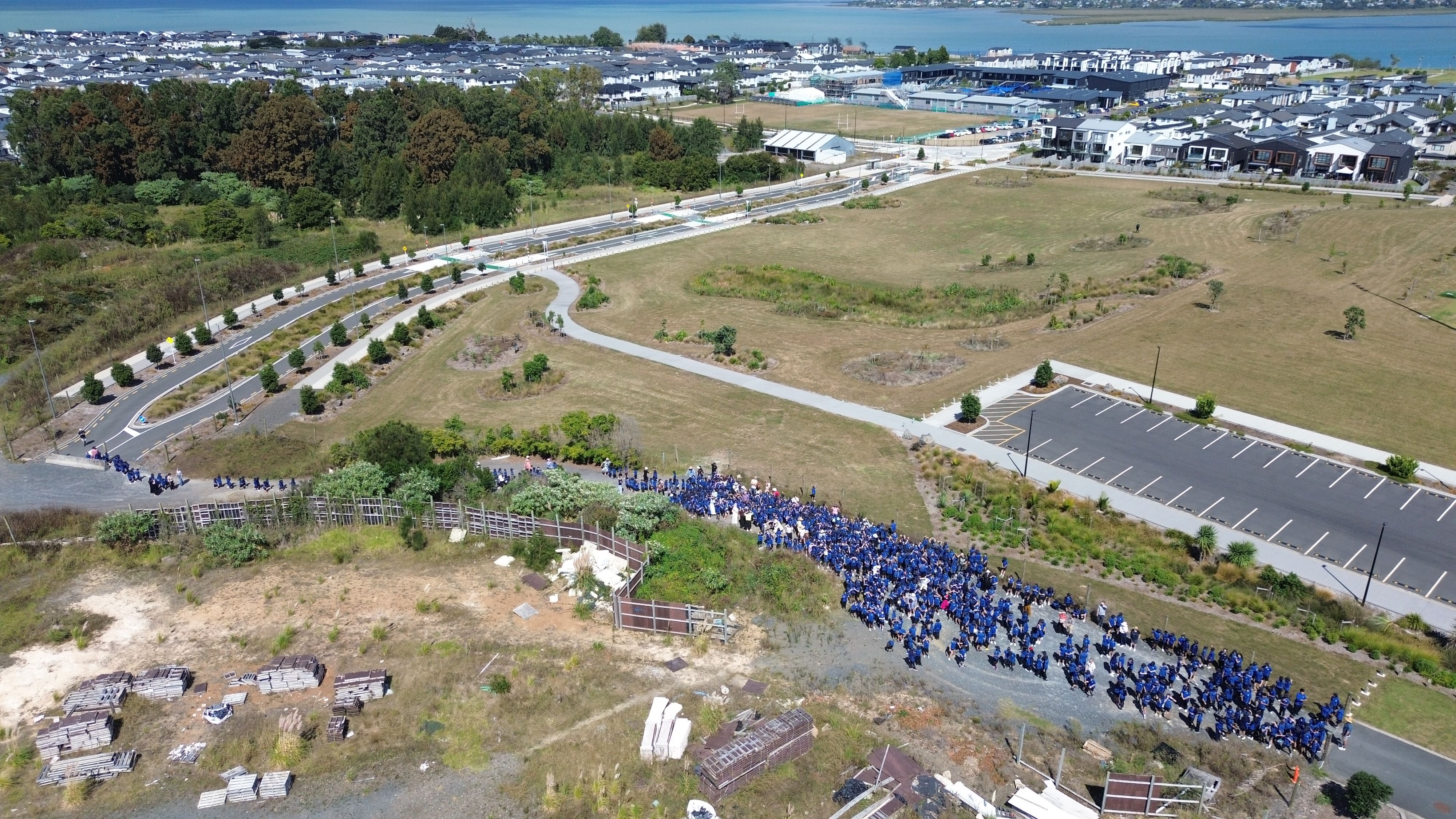 Students of Scott Point School standing at the incomplete road that will now open in June.