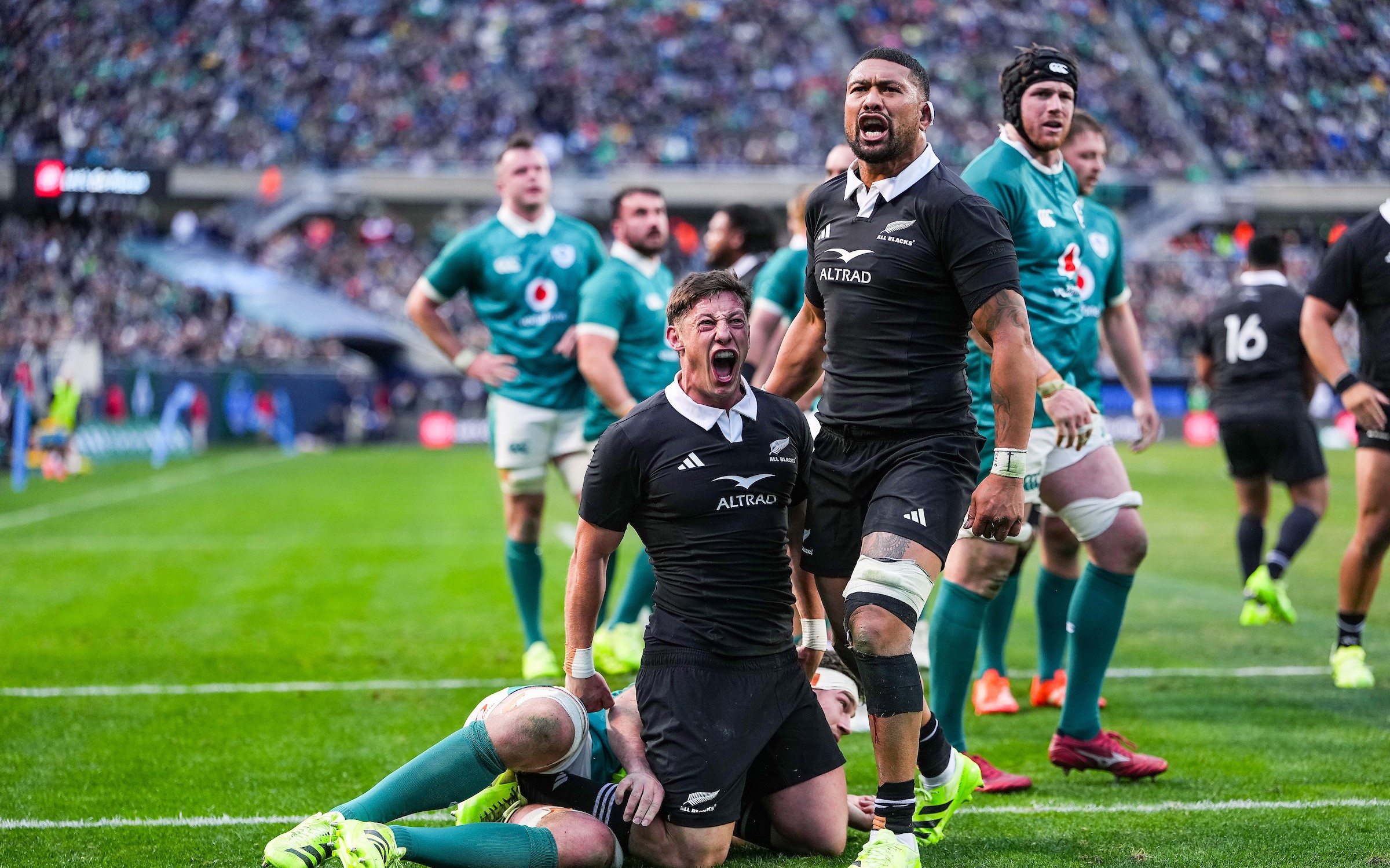 Cam Roigard and Ardie Savea celebrate Roigard's try against Ireland in Chicago.