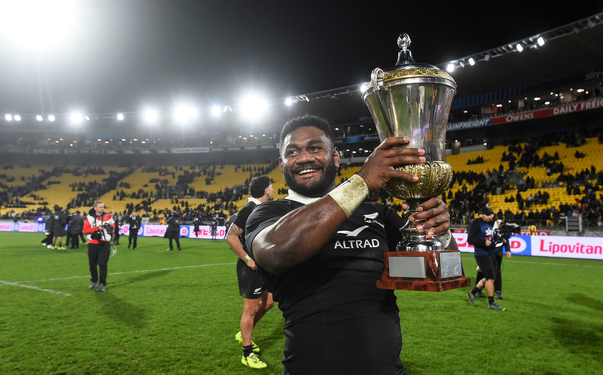 Timoci Tavatavanawai celebrates the All Blacks' win with the Dave Gallaher Trophy.