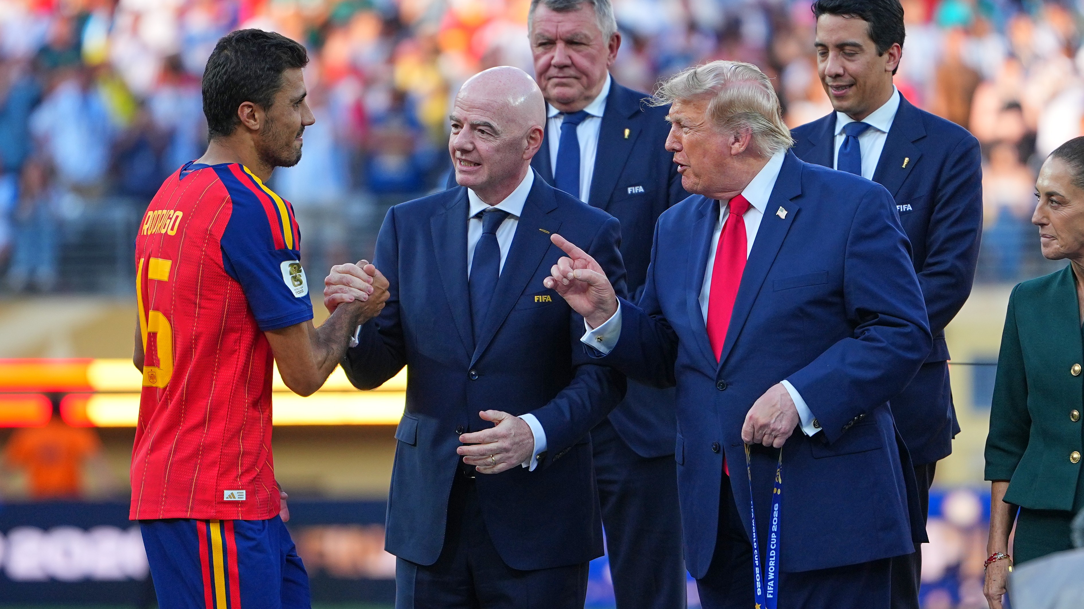 Spain's Rodri (16) is greeted by FIFA President Gianni Infantino and President Donald Trump during the presentation ceremony after the World Cup final match between Spain and Argentina.