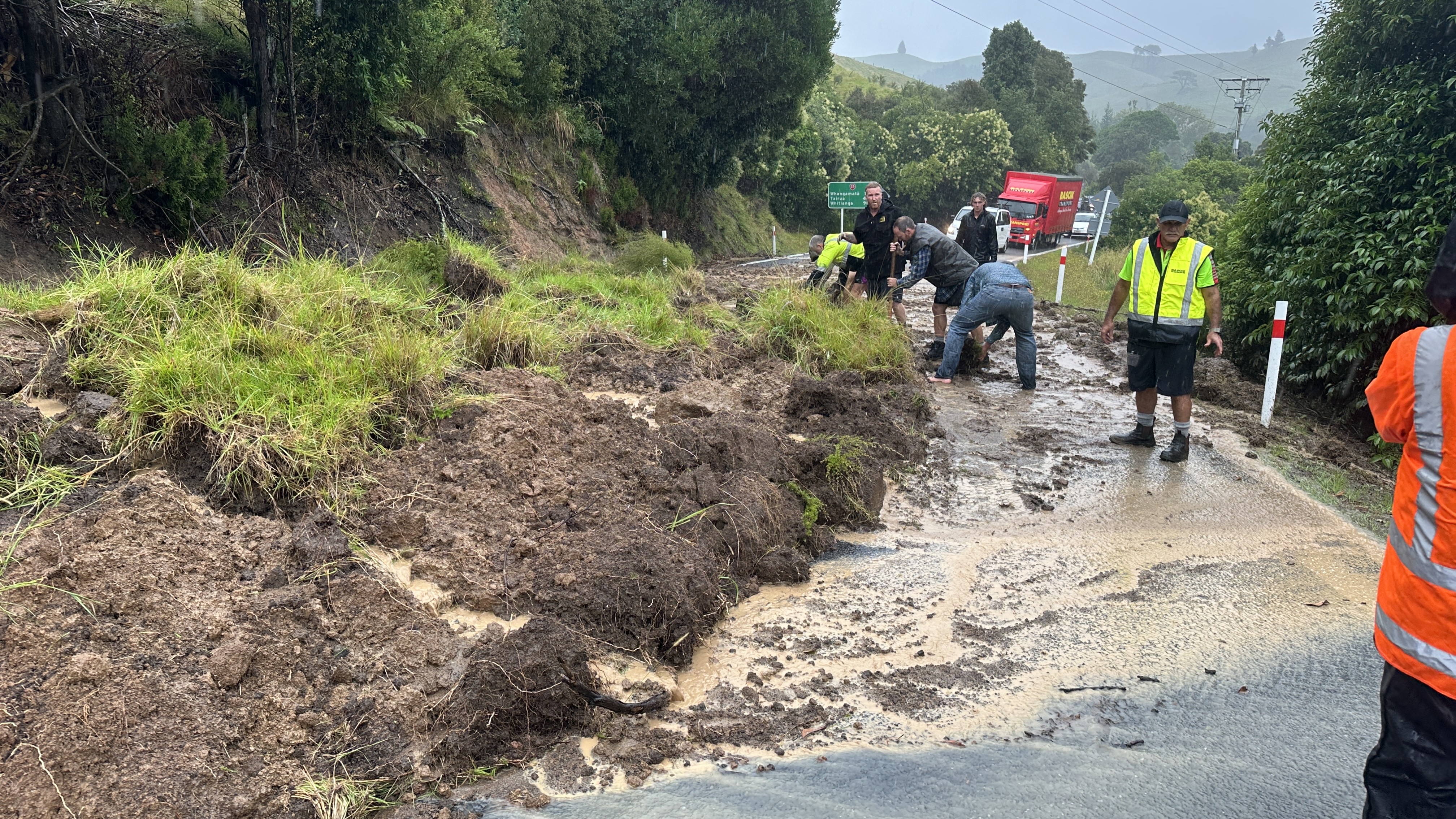 People get stuck into a slip on State Highway 25 near Whiritoa.