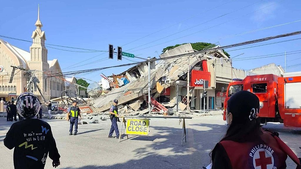 A collapsed commercial building is seen following a magnitude 8.2 earthquake in Mindanao, Philippines.
