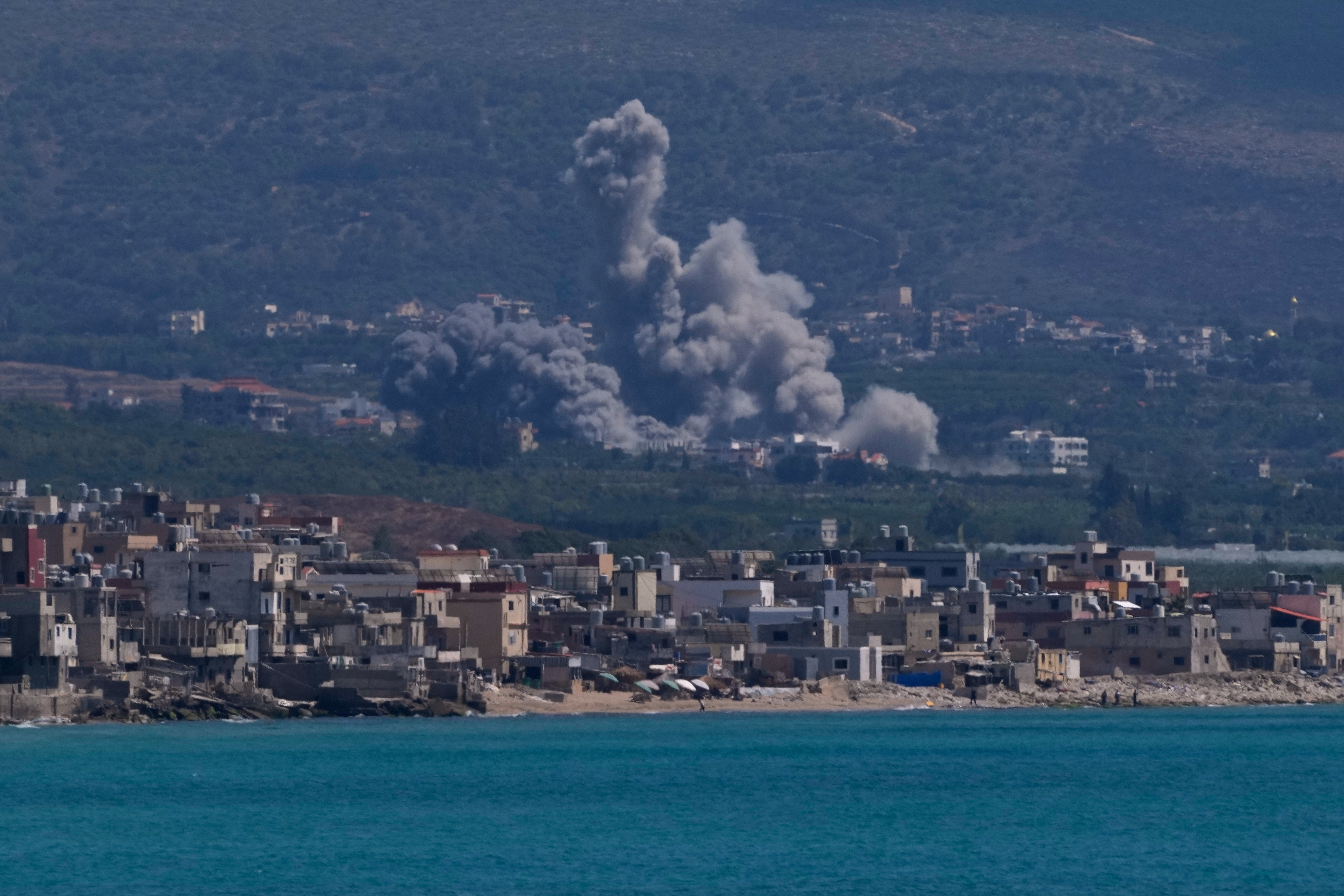 Smoke rises from an Israeli airstrike that hit Qlaileh village, as it seen from the southern port city of Tyre, Lebanon