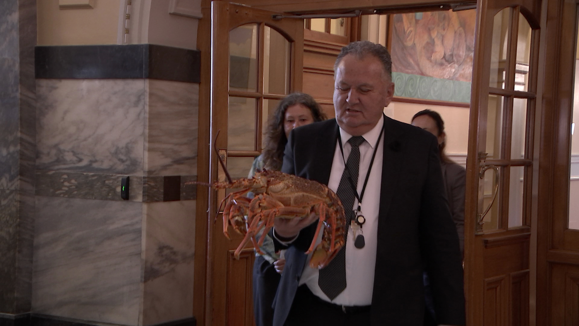 Oceans and Fisheries Minister Shane Jones parades a live crayfish in front of journalists in late May.