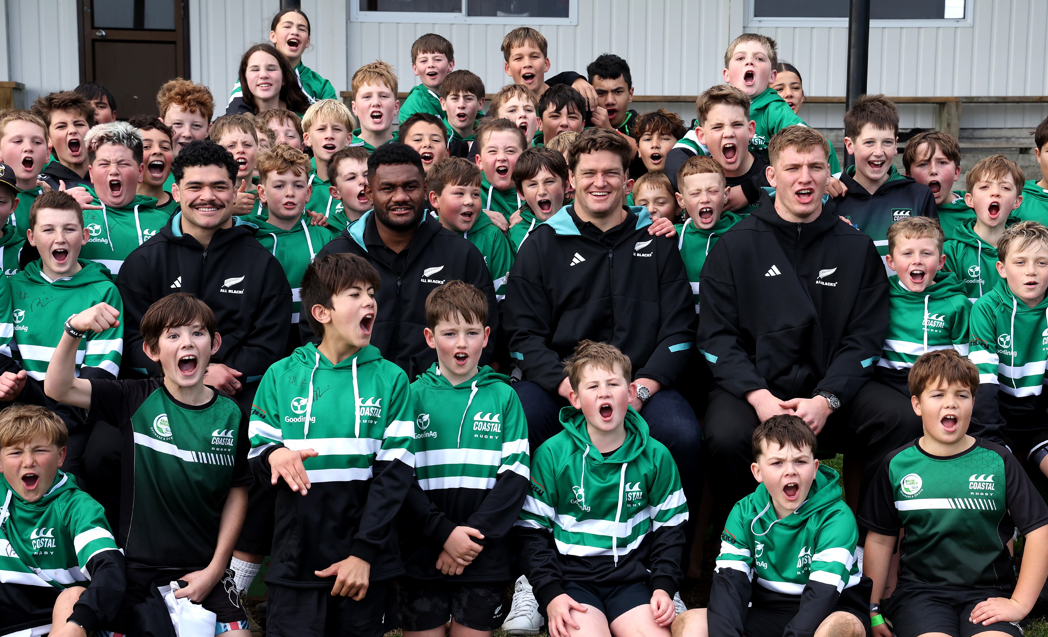 All Blacks, from left, Du'Plessis Kirifi, Timoci Tavatavanawai, Scott Barrett and Fabian Holland with members of the Coastal Rugby Club.
