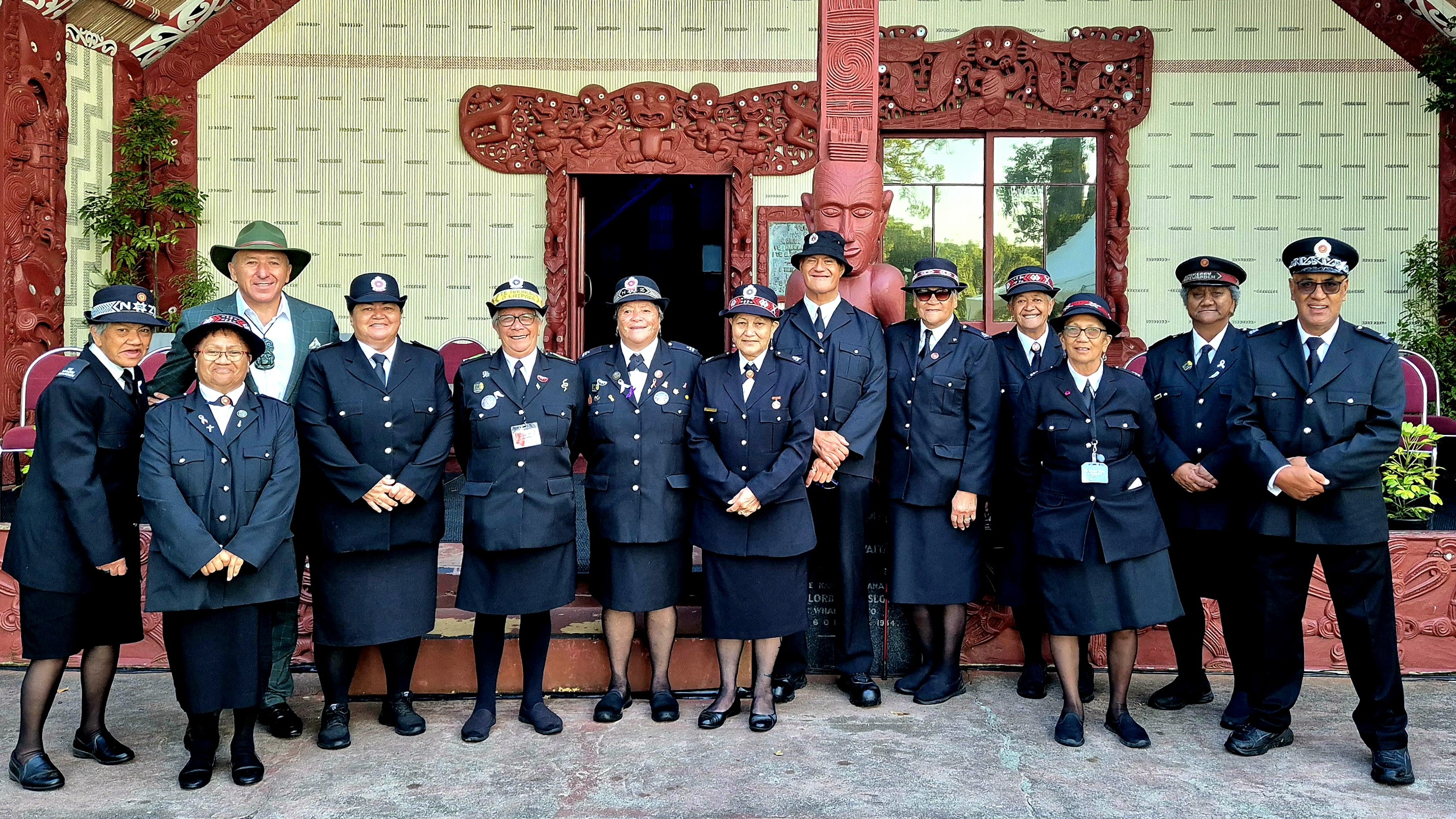 Pita Tipene, third from left, Chair of the Waitangi National Trust Board, with Māori Wardens, outside the Whare Runanga at Waitangi.