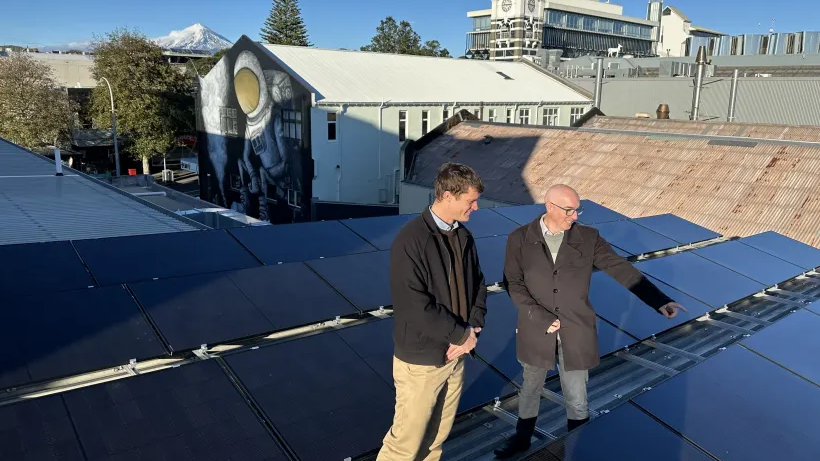 NPDC Energy and Infrastructure Adviser Mat Sycamore, left, and Climate Change Response Lead Greg Stephens inspect the new solar panels on the TSB Showplace.