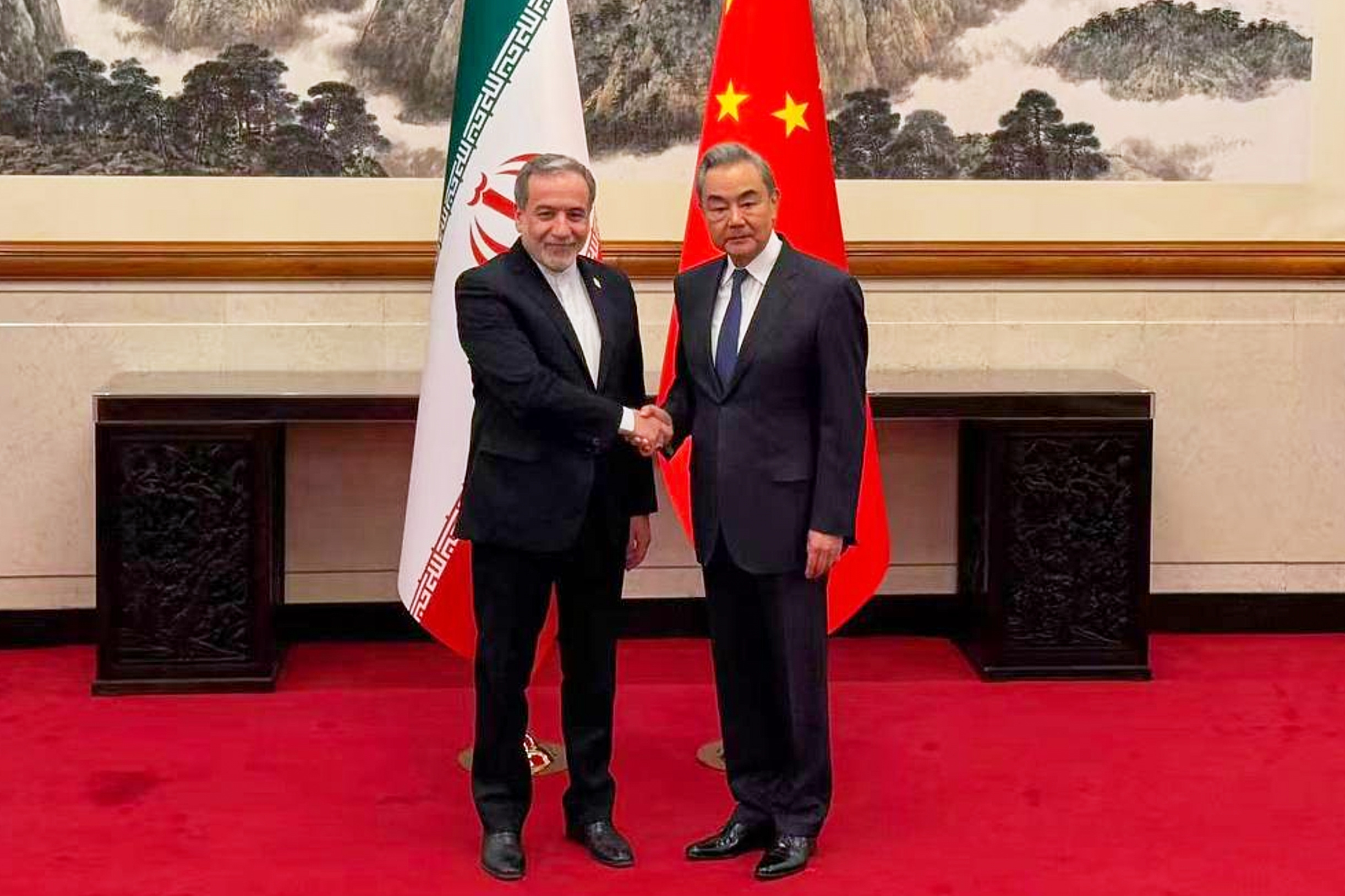In this photo released by the Telegram channel of Iranian Foreign Minister Abbas Araghchi, China's Foreign Minister Wang Yi, right, meets with Iran's Foreign Minister Abbas Araghchi in Beijing, China