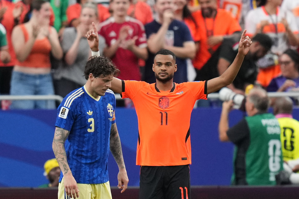 Netherlands' Cody Gakpo celebrates scoring his side's third goal against Sweden during a World Cup Group F soccer match in Houston.