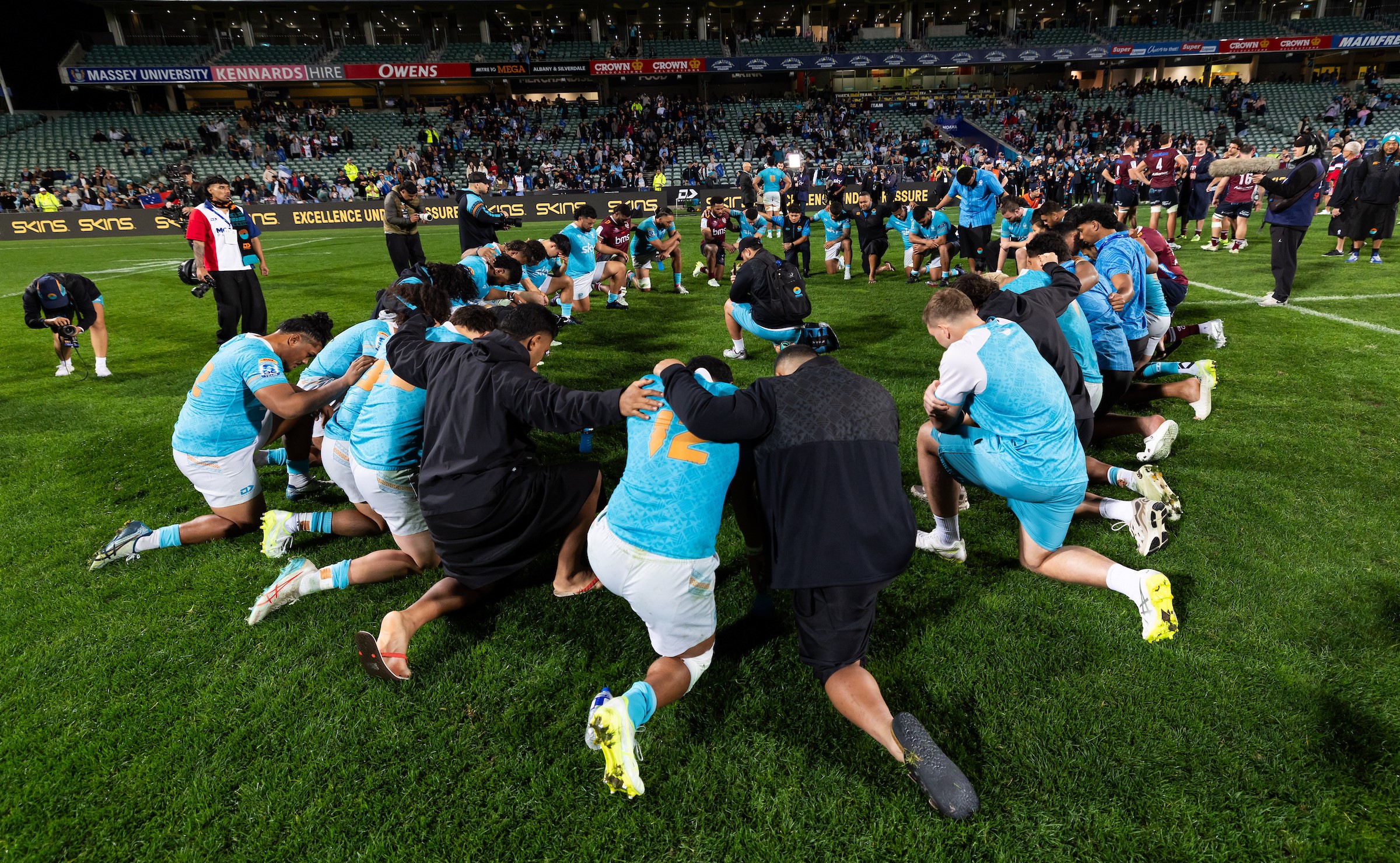 Moana Pasifika's players react to their defeat to the Reds at North Harbour Stadium.