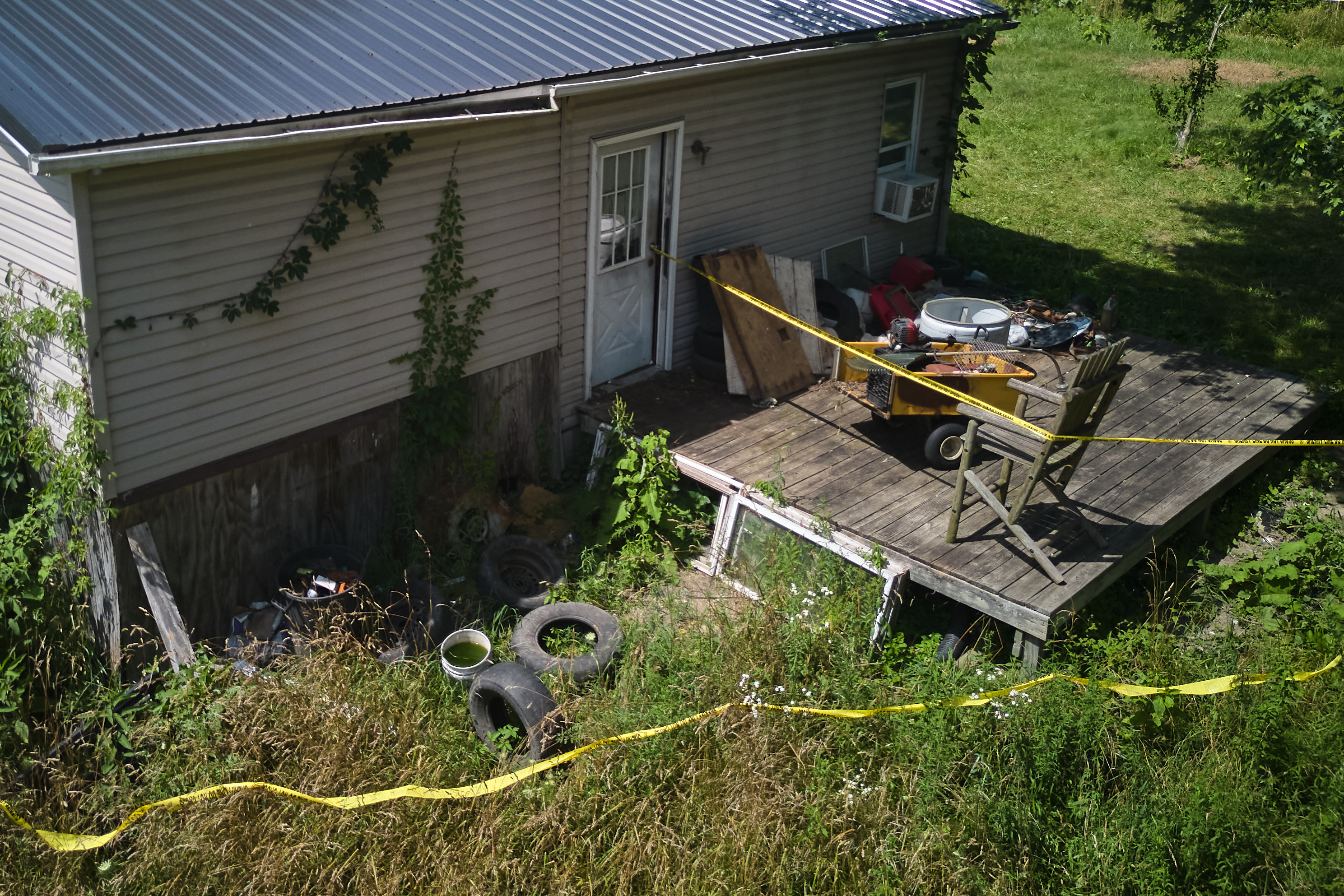 Police tape surrounds a home where authorities say they removed 16 children and arrested four adults in Hamden, Ohio, Wednesday, July 1, 2026.