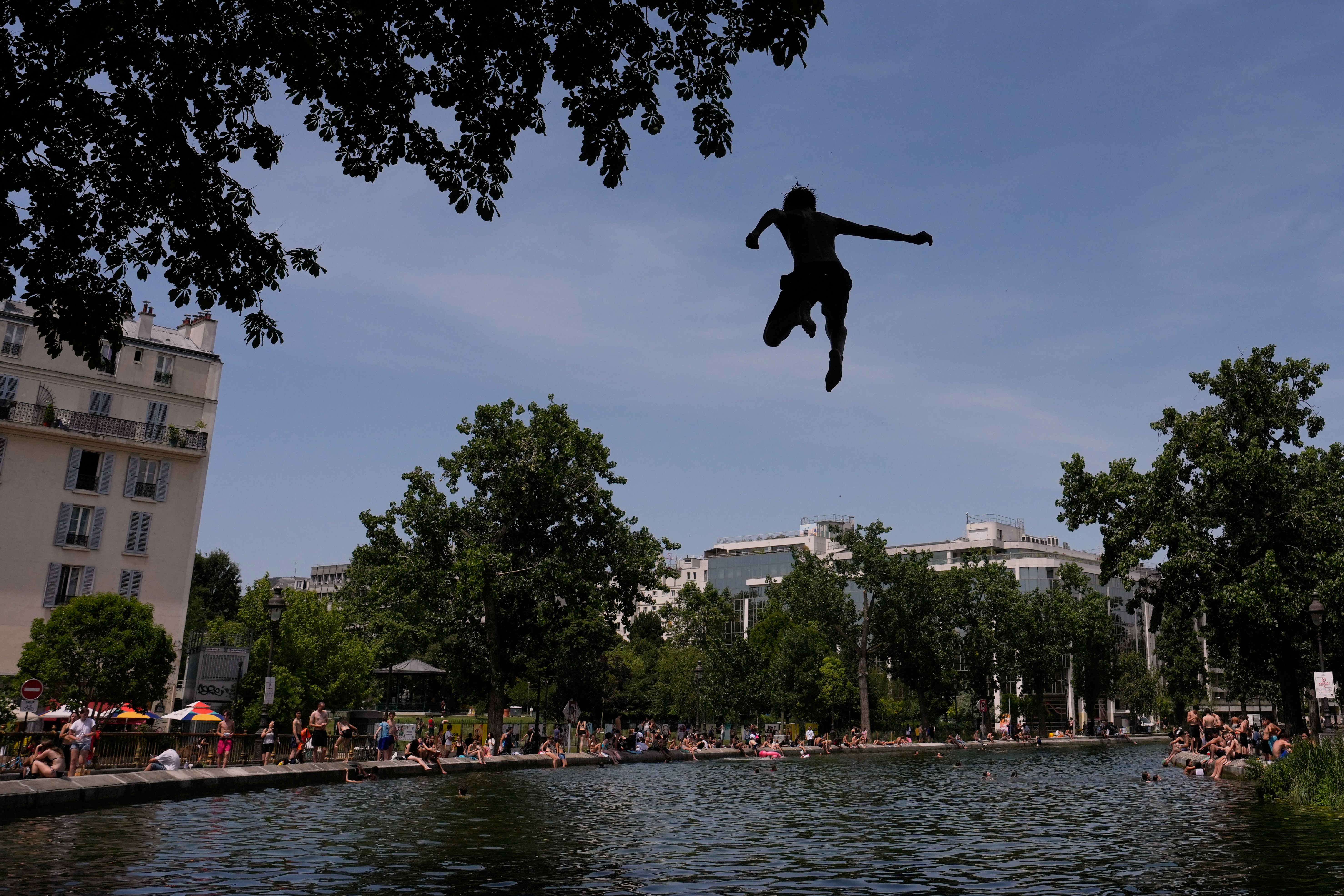 Parisians bath in the Canal Saint-Martin in Paris, as the national weather service, Meteo France, placed 54 departments, about half the country, under a red heat wave alert.