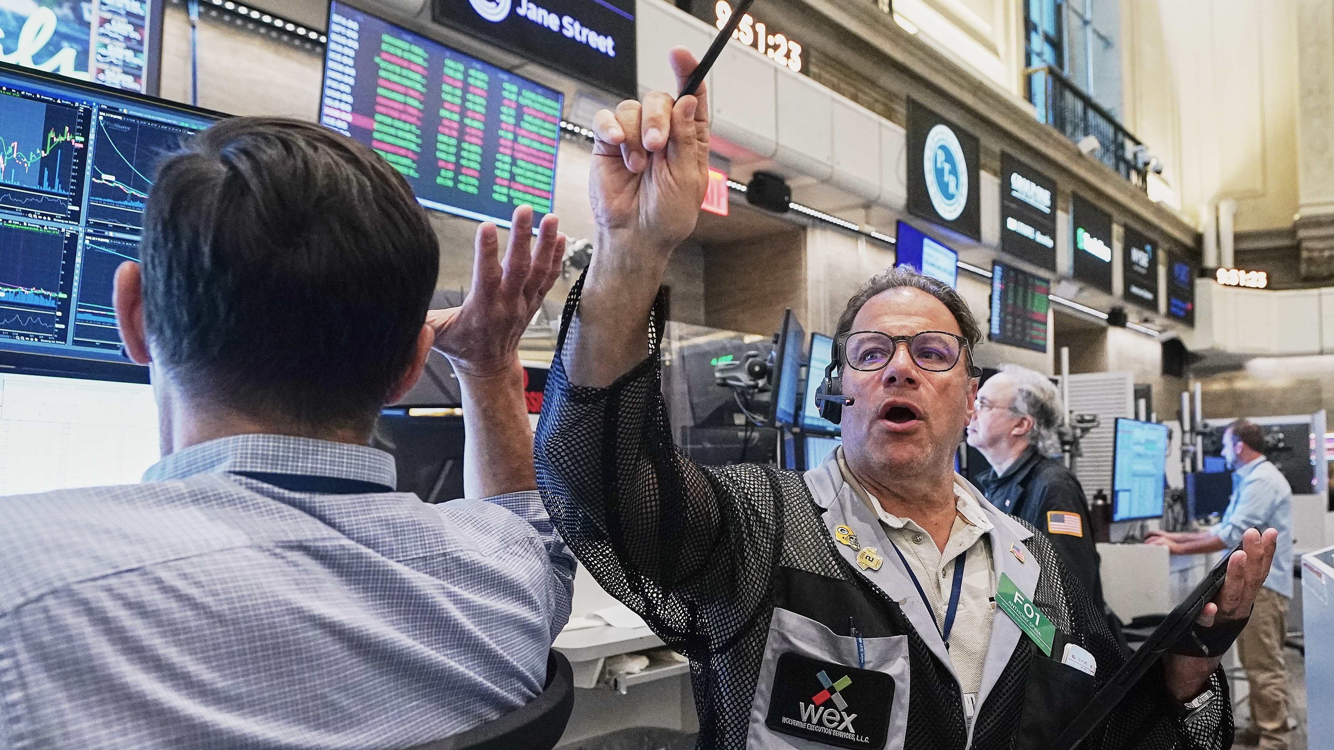 Options trader Anthony Spina, center, works on the floor of the New York Stock Exchange.