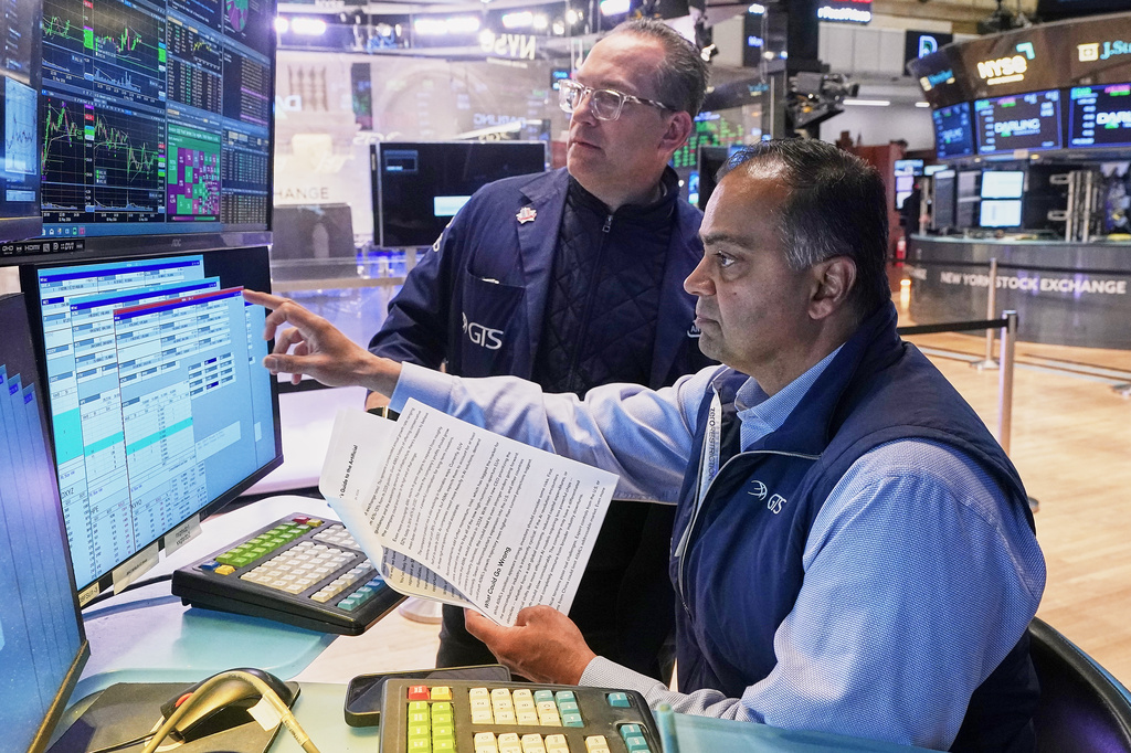 Specialists Anthony Matesic, left, and Dilip Patel work on the floor of the New York Stock Exchange, Monday, May 11, 2026.