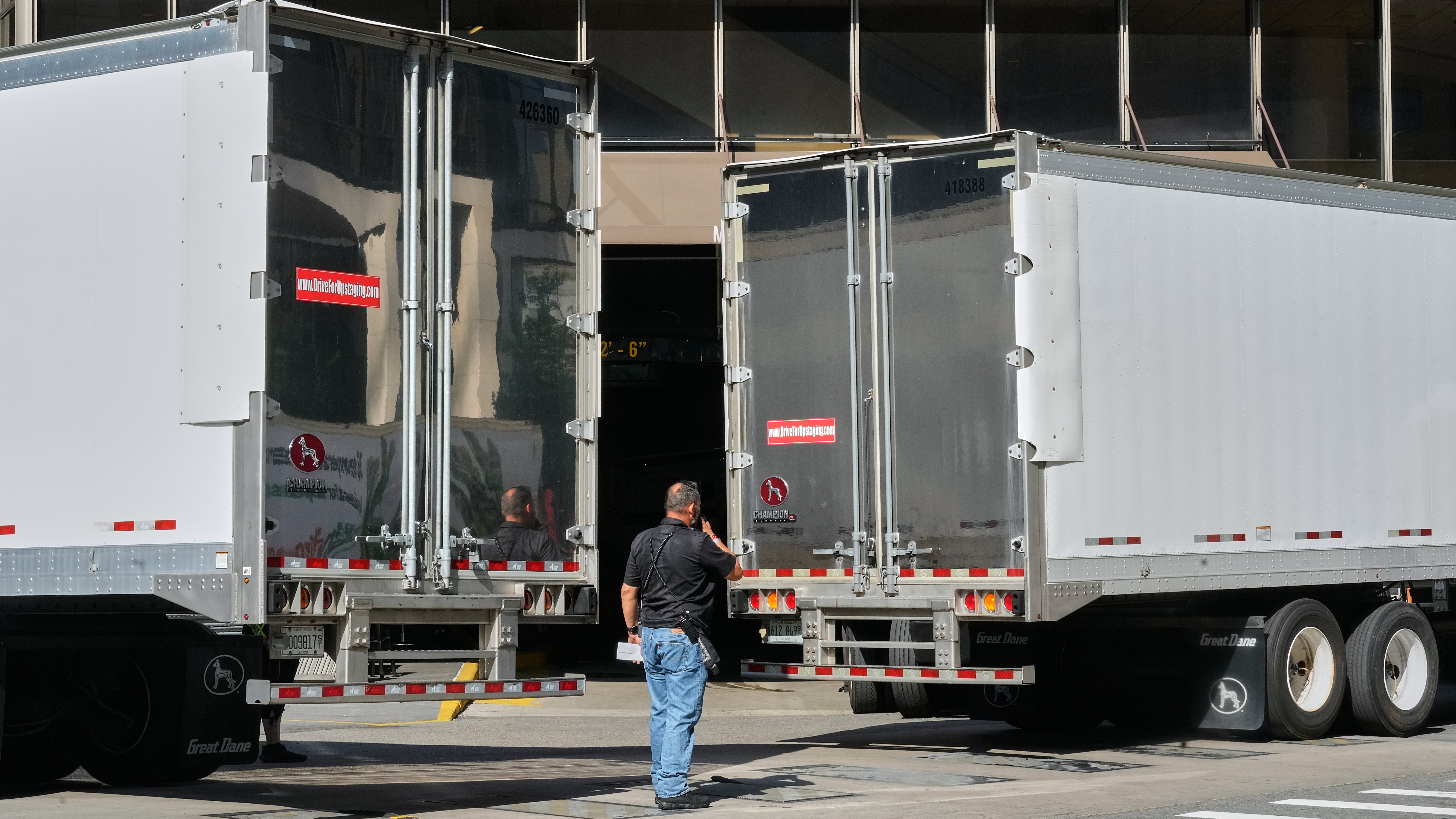 Trucks are moved into position to block photographer's view of the loading dock at New York's Madison Square Garden.