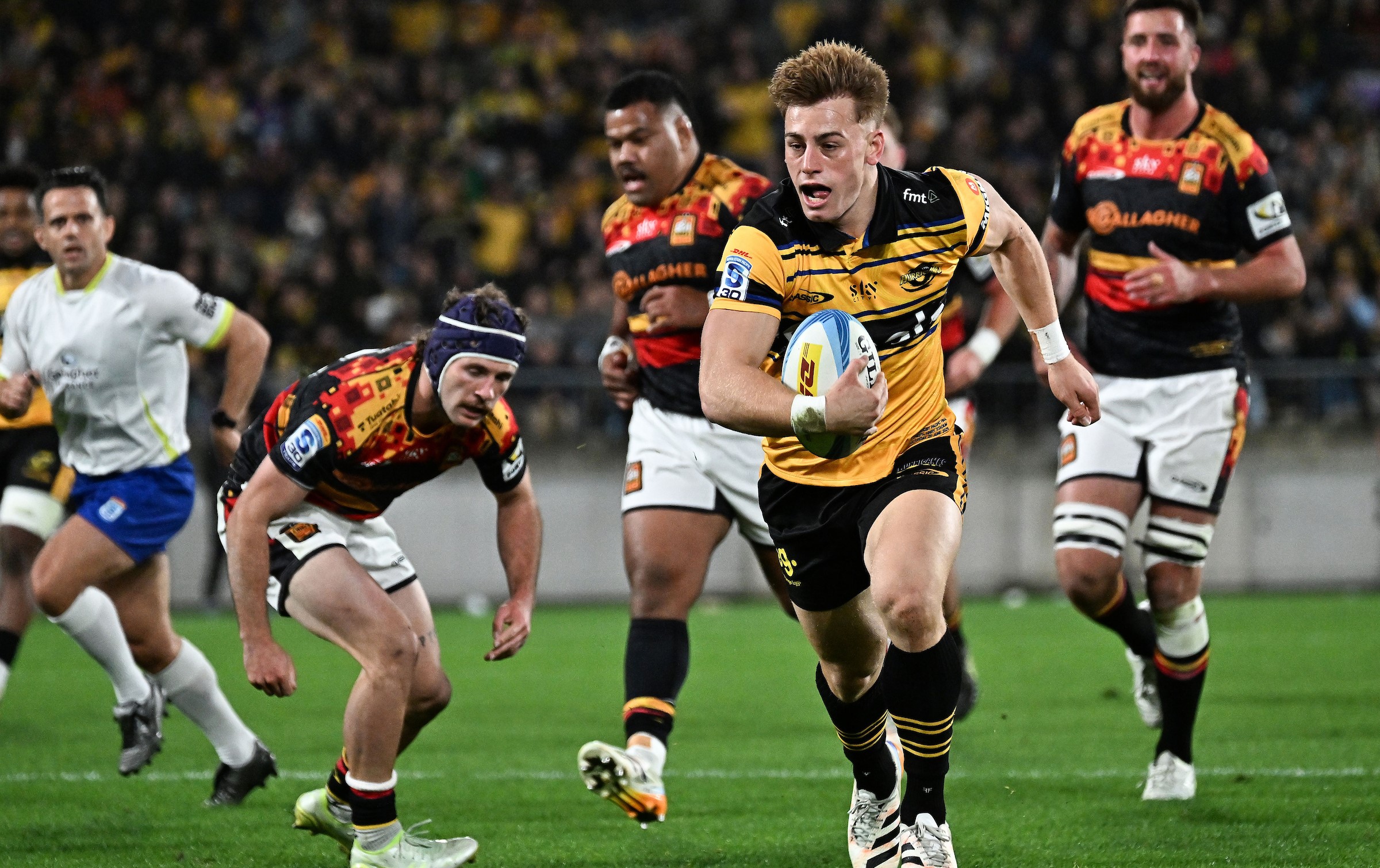 Hurricanes first-five Ruben Love runs in for his first try of the grand final against the Chiefs in Wellington.