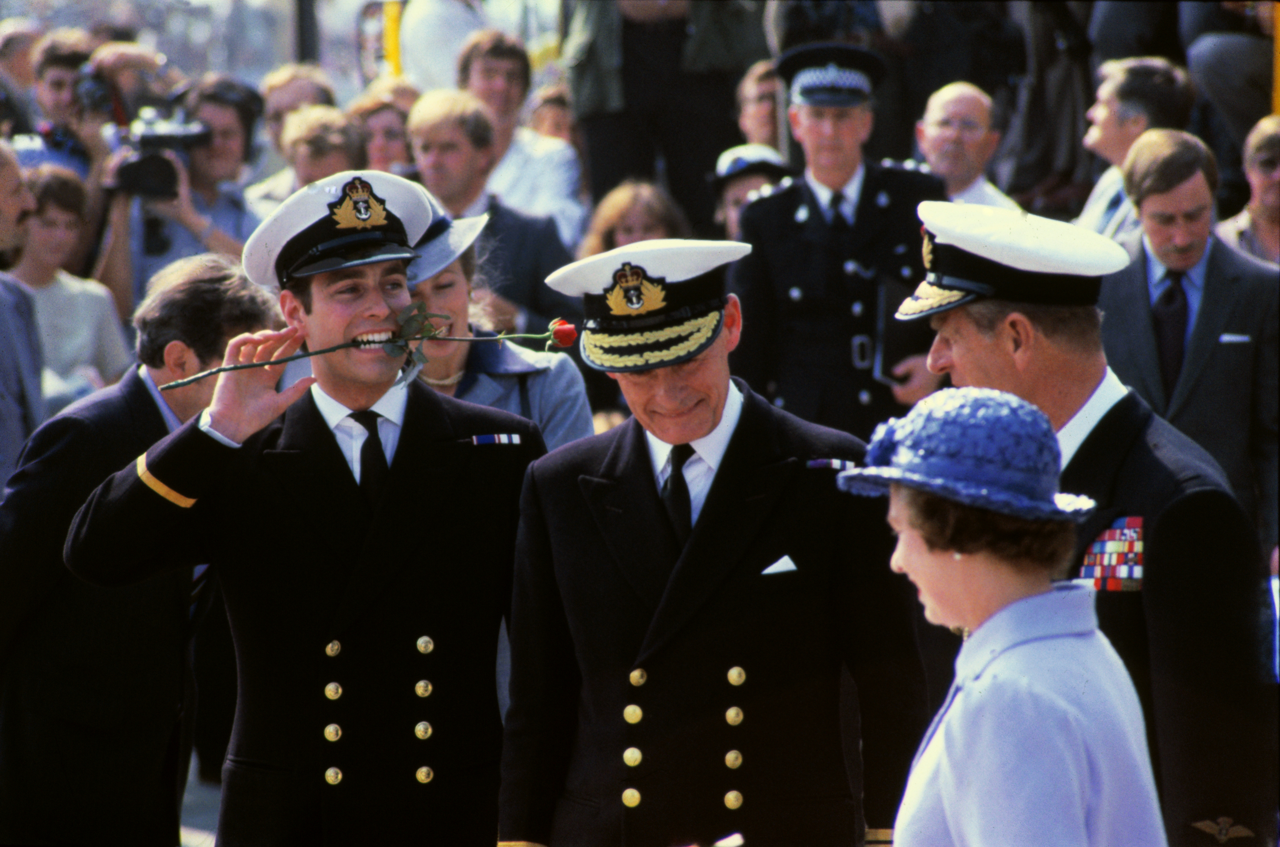 Prince Andrew holds a rose in his mouth following his return from the Falklands,. 