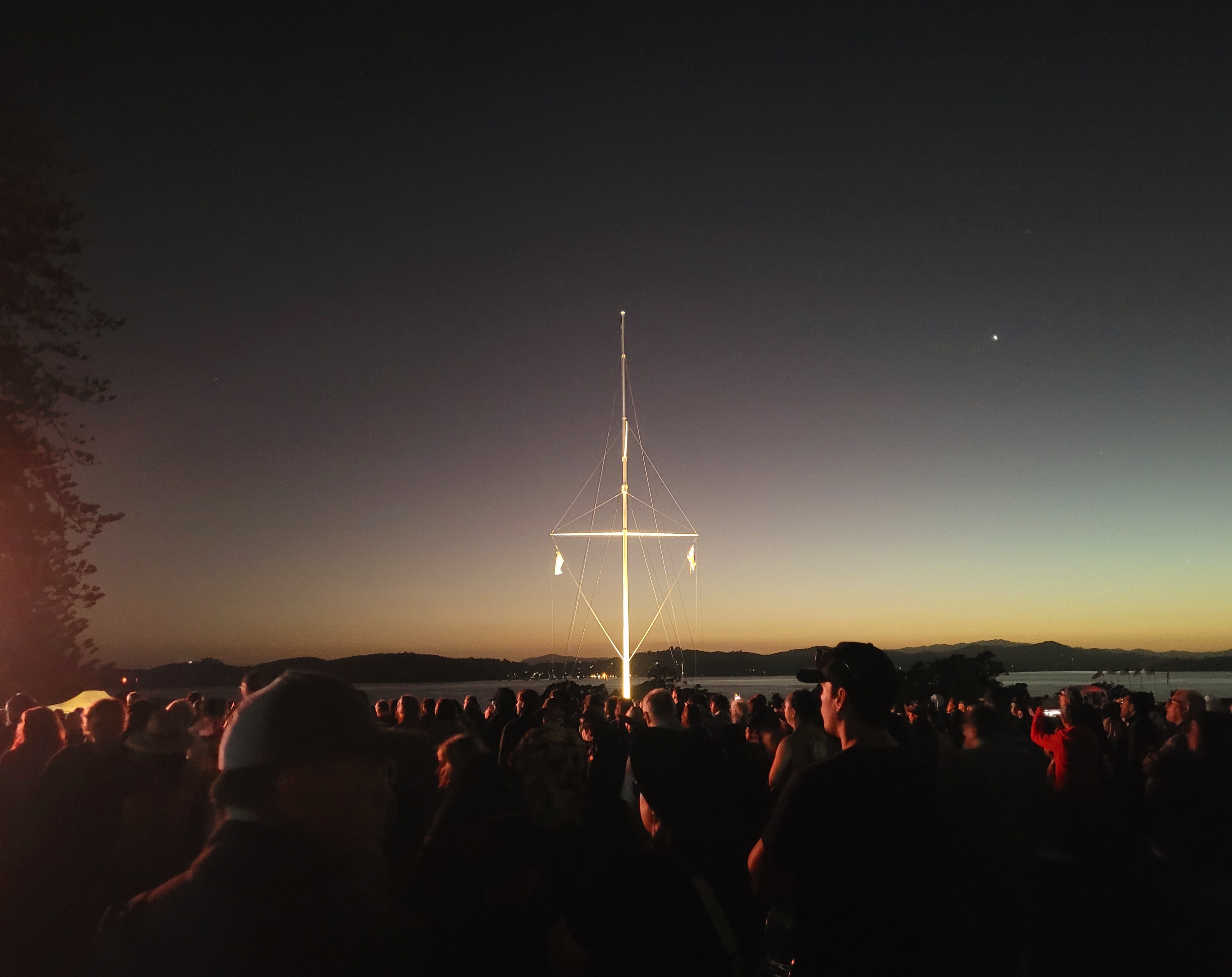 People, stretching far beyond the famous flagstaff, as the sun prepares to rise over the Pacific. 