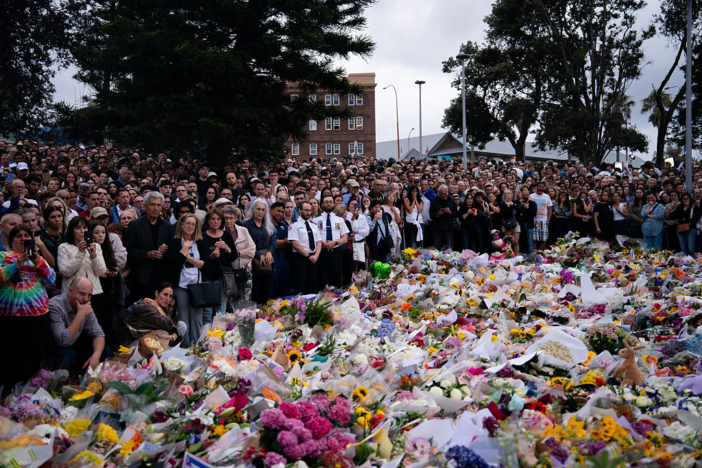 People participate in a candlelight vigil at Bondi Pavilion at Bondi Beach.