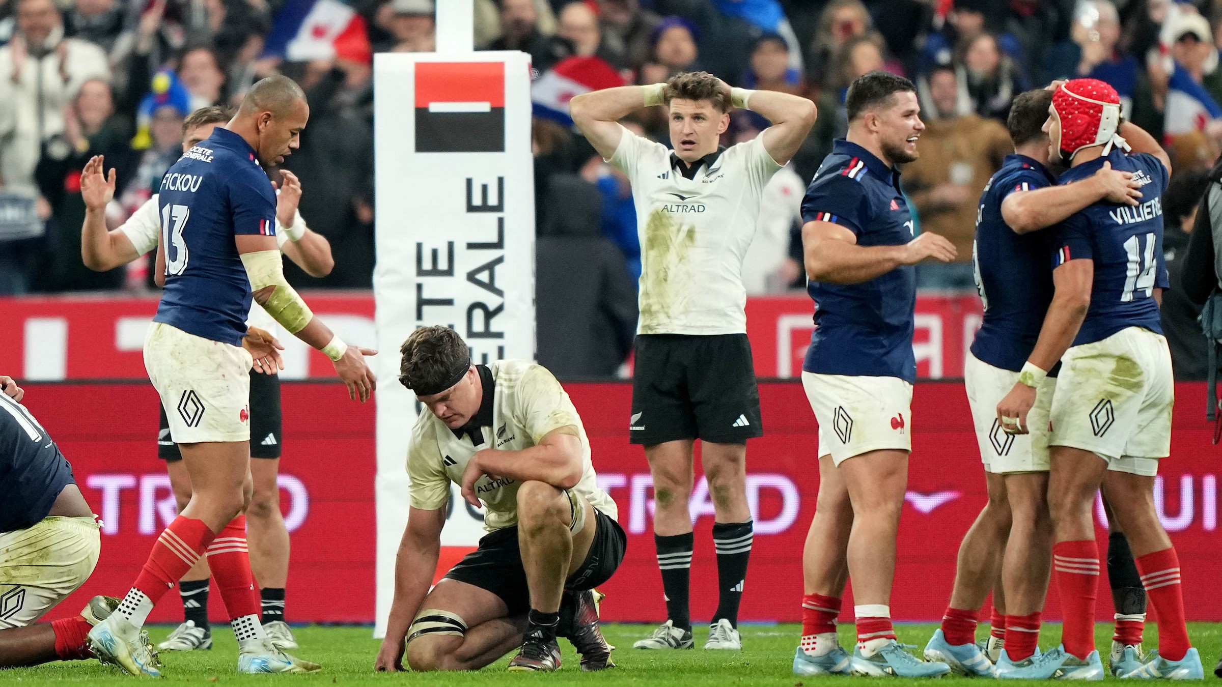 The All Black Barrett brothers Scott, left, and Beauden wonder what might have been as the French celebrate their victory at the Stade de France.