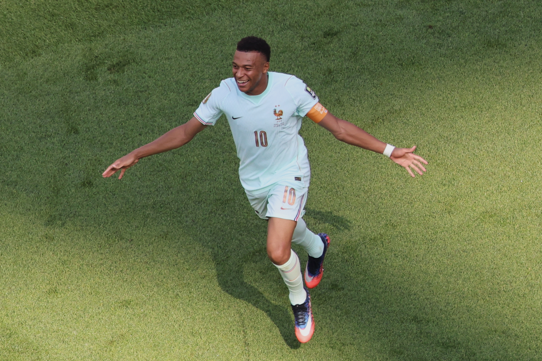 France's Kylian Mbappe (10) celebrates scoring the opening goal during the World Cup quarterfinal soccer match between France and Morocco.