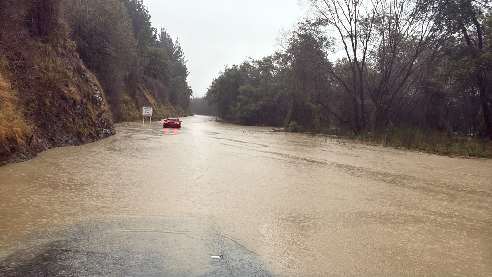 The Conway River has burst its banks and flooded parts of SH1.