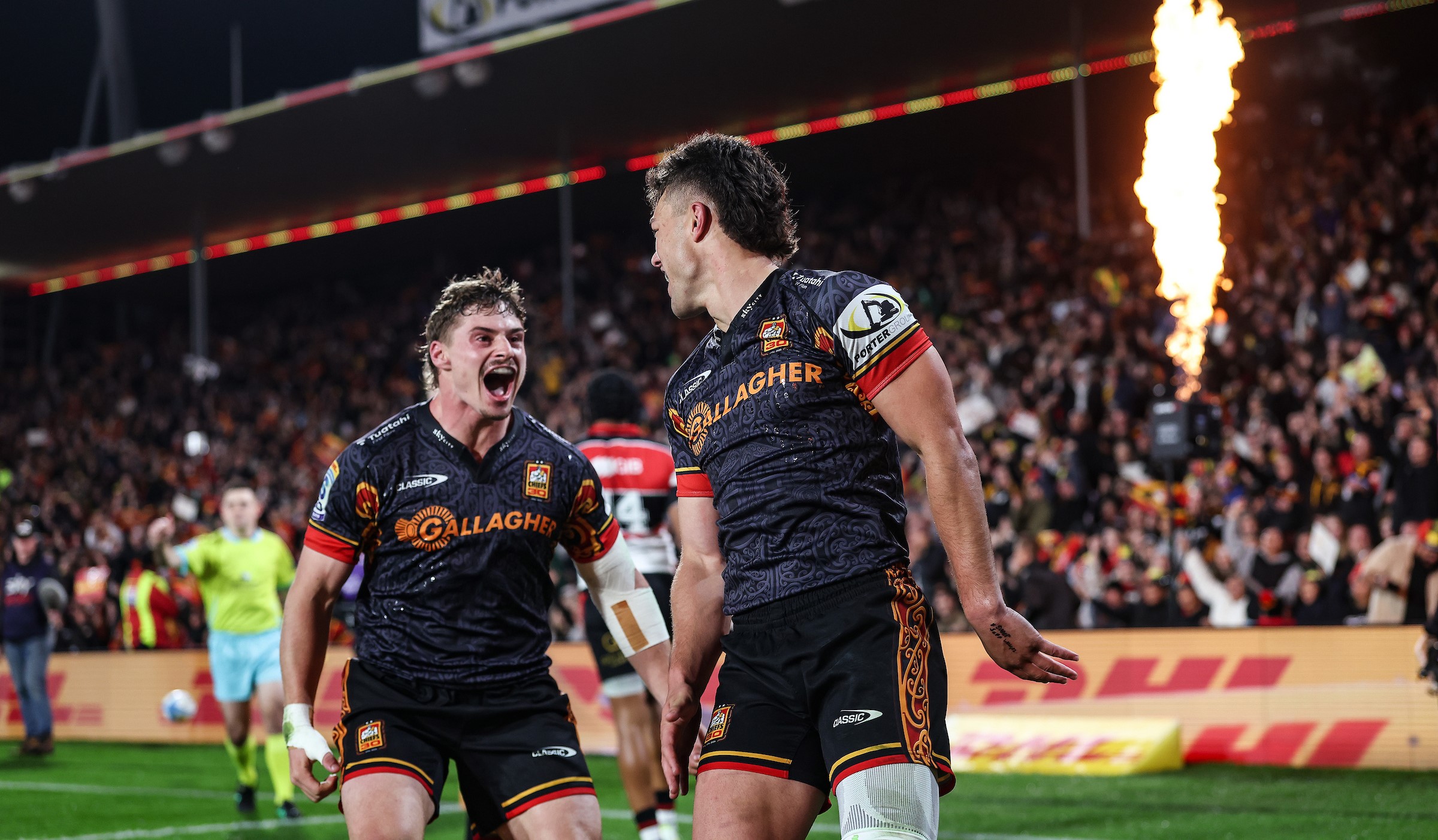 Isaac Hutchison of the Chiefs, left, celebrates a try from Kyren Taumoefolau against the Crusaders.