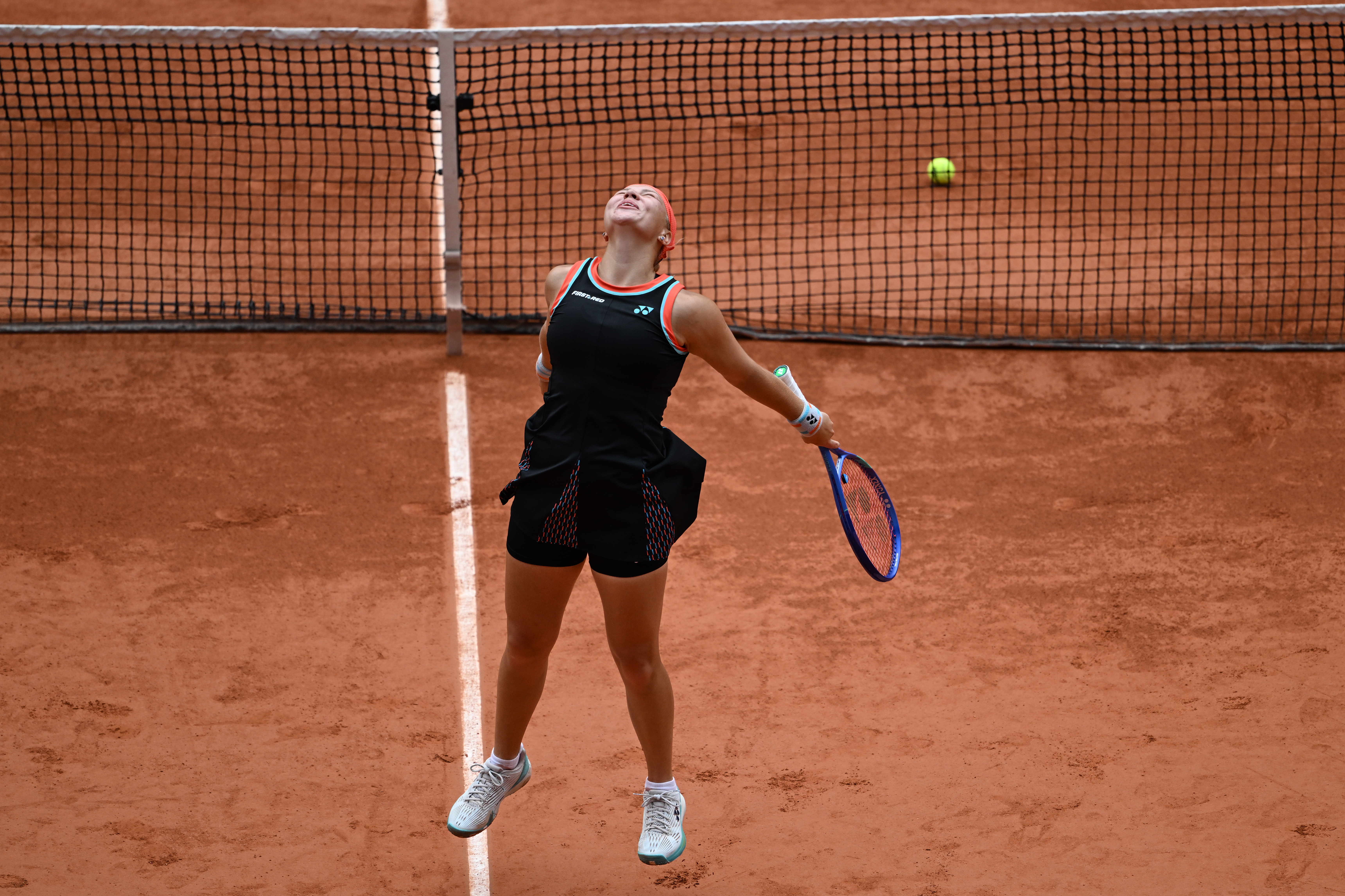 Russia's Diana Shnaider reacts after winning the quarterfinal tennis match against Aryna Sabalenka of Belarus at the French Open in Paris
