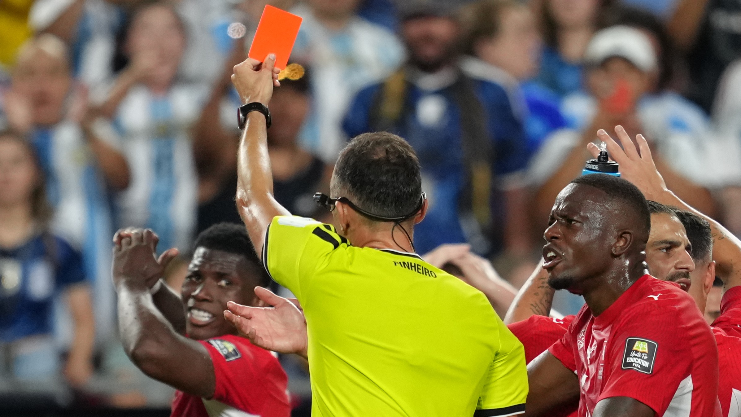 Referee Joao Pinheiro, of Portugal, gives a red card to Switzerland's Breel Embolo (7), left, during the World Cup quarterfinal soccer match between Argentina and Switzerland in Kansas City, Mo., Saturday, July 11, 2026.