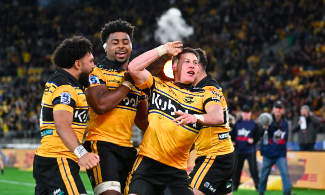 Cam Roigard celebrates a try with teammates during the Hurricanes' Super Rugby Pacific semifinal against the Blues at Hnry Stadium, Wellington