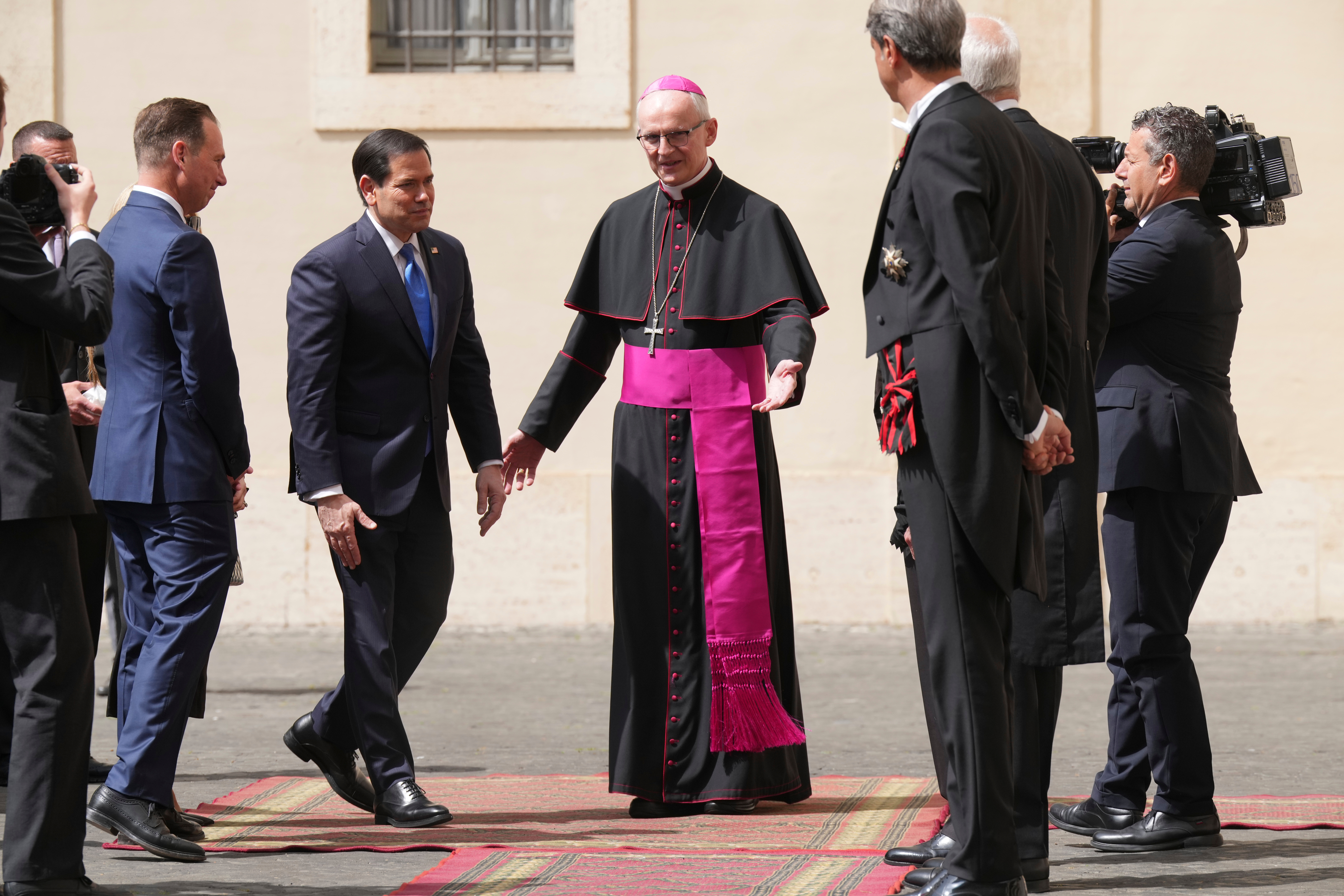 US Secretary of State Marco Rubio is greeted by Archbishop Petar Rajič, the new Prefect of the Papal Householdas as he arrives at the St. Damasus courtyard to meet with Pope Leo XIV and Vatican Secretary of State Pietro Parolin the Vatican