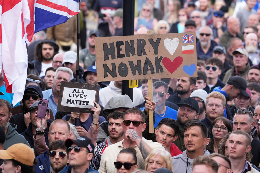 People gather to protest outside Southampton police station, Southampton, England, Tuesday June 2, 2026, after the fatal stabbing of Henry Nowak, a British teenager who was handcuffed despite claiming he was the crime victim