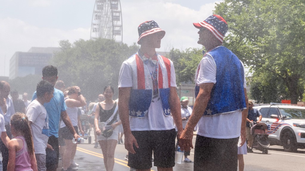 Attendees cool off in mist at the Great American State Fair on the National Mall in Washington.