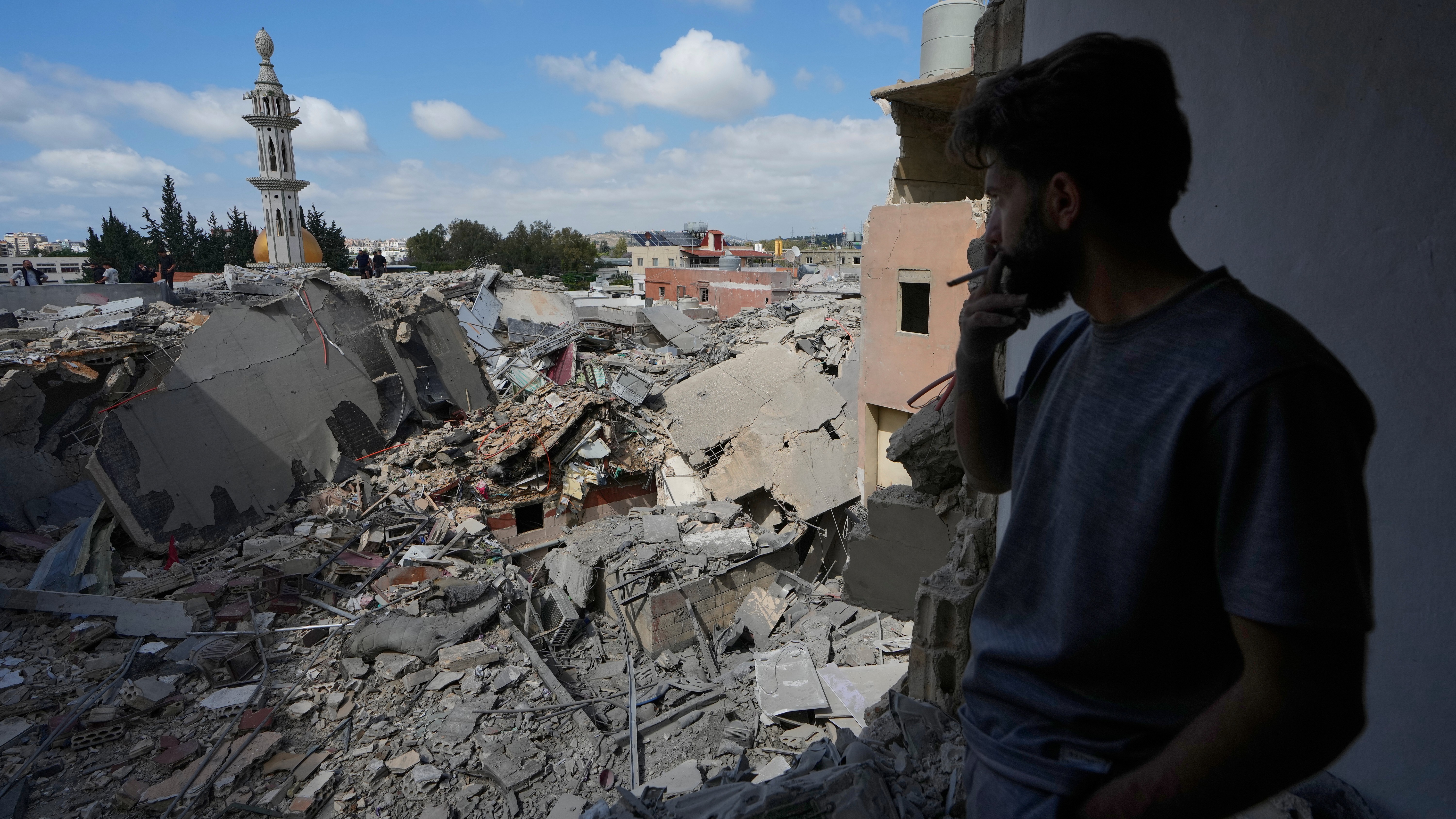 A man looks at a destroyed building that was hit in an Israeli airstrike in Burj al-Shemali village near the southern port city of Tyre, Lebanon, Tuesday, May 26, 2026.