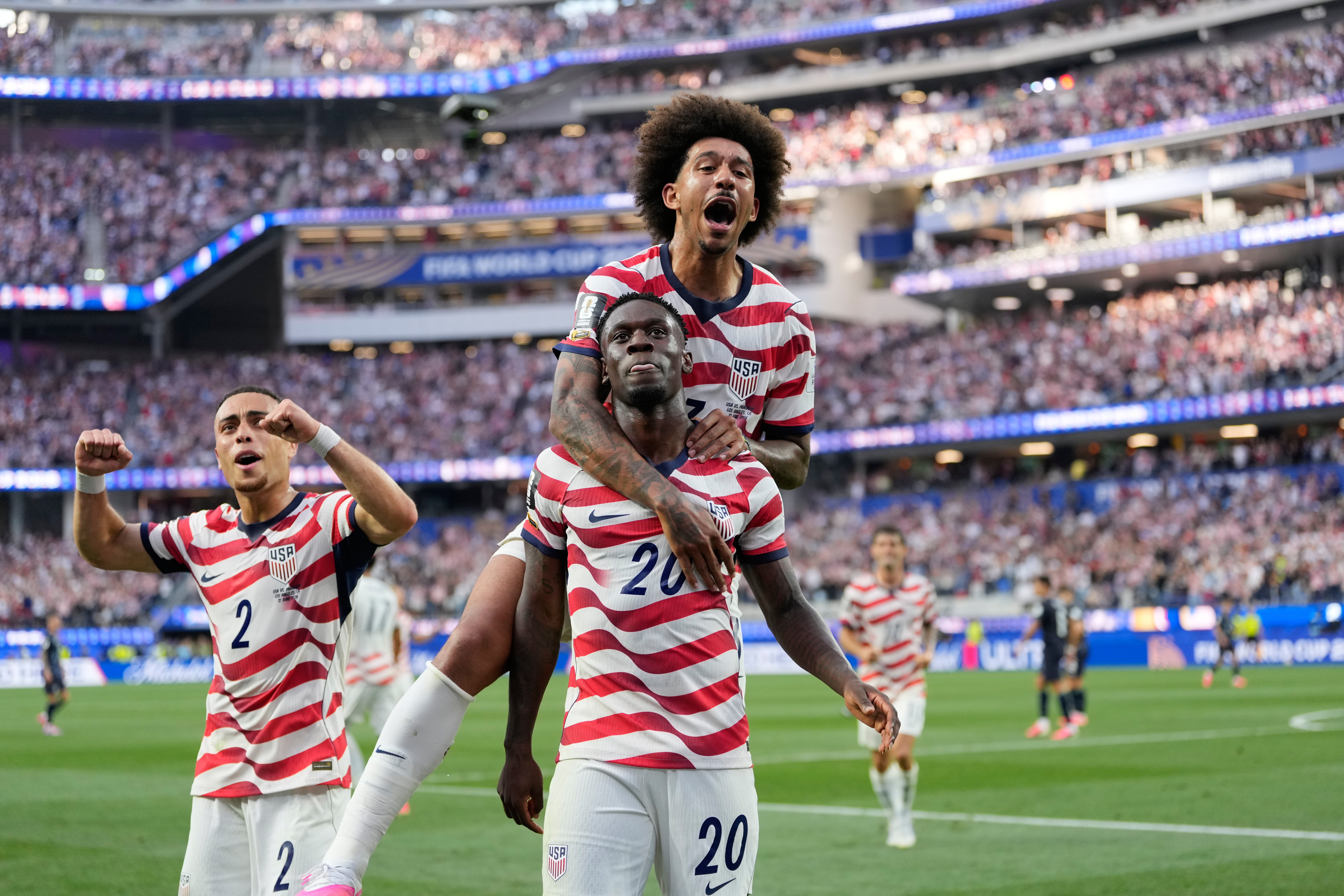 United States' Folarin Balogun (20) celebrates scoring his side's third goal against Paraguay with teamates during the World Cup Group D soccer match in Inglewood, Calif., near Los Angeles, Friday, June 12, 2026.