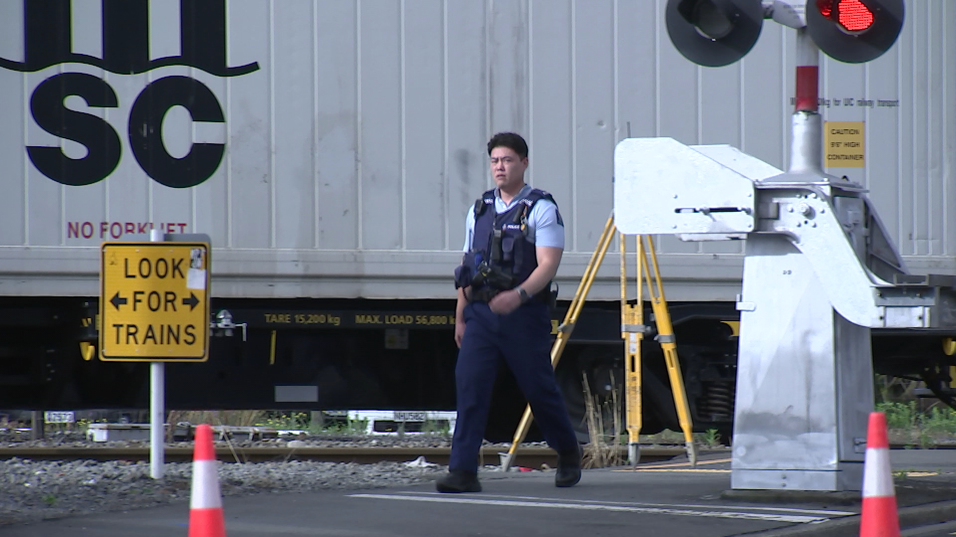 Police at the scene of a fatal collision between a scooter and a train on Christchurch's Lincoln Rd.