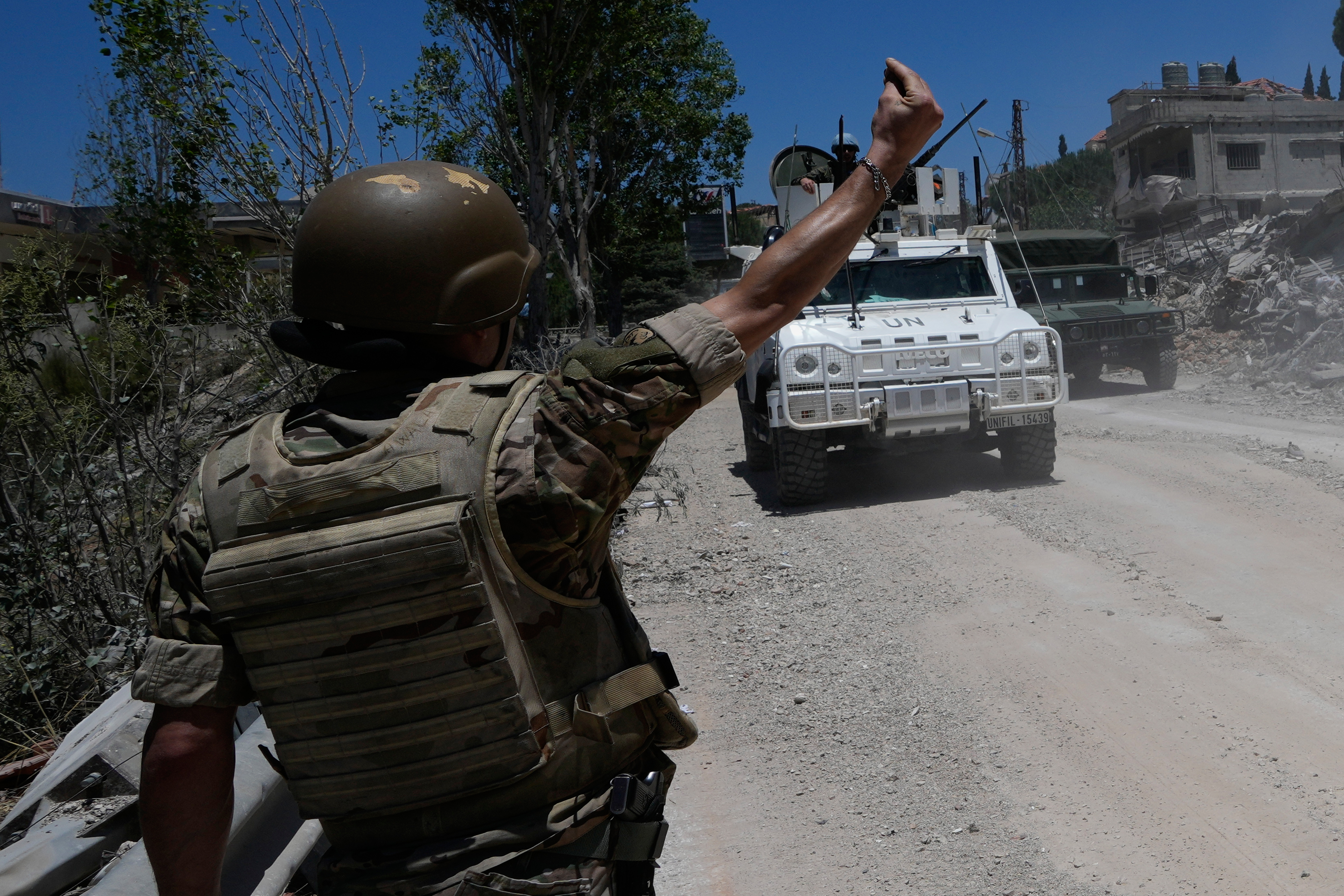 A Lebanese soldier gestures in front of a Spanish UN peacekeeper vehicle Dibbine village, southeast Lebanon, Friday, June 5, 2026, a day after Israeli forces withdrew following clashes with Hezbollah fighters. 