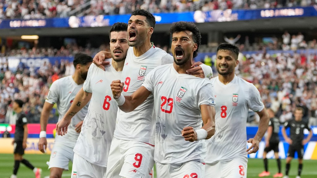 Iran's Ramin Rezaeian (23) celebrates with his teammates after scoring a goal during the World Cup Group G soccer match between Iran and New Zealand in Inglewood, California.
