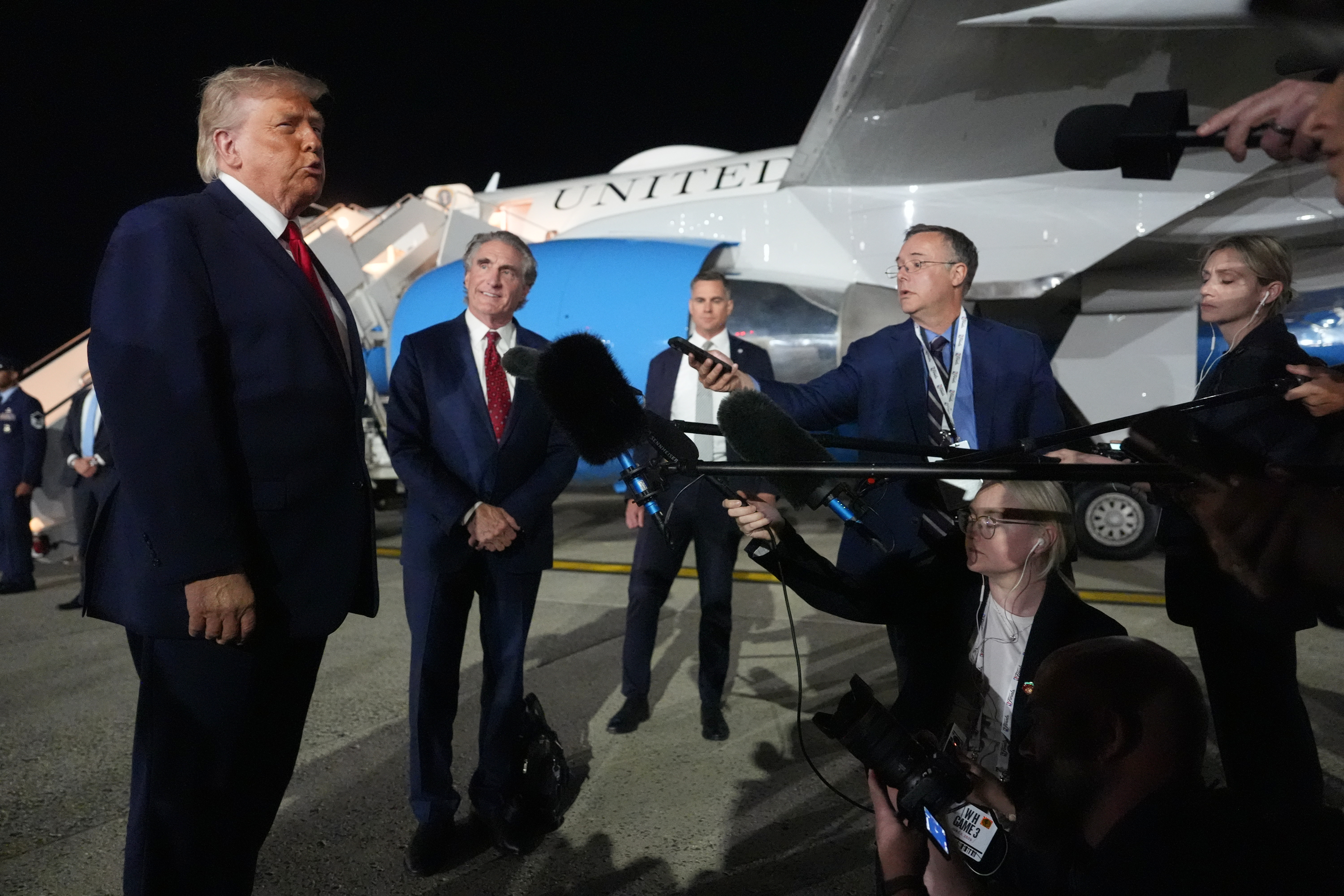 President Donald Trump talks with reporters before boarding Air Force One at John F. Kennedy International Airport in New York.