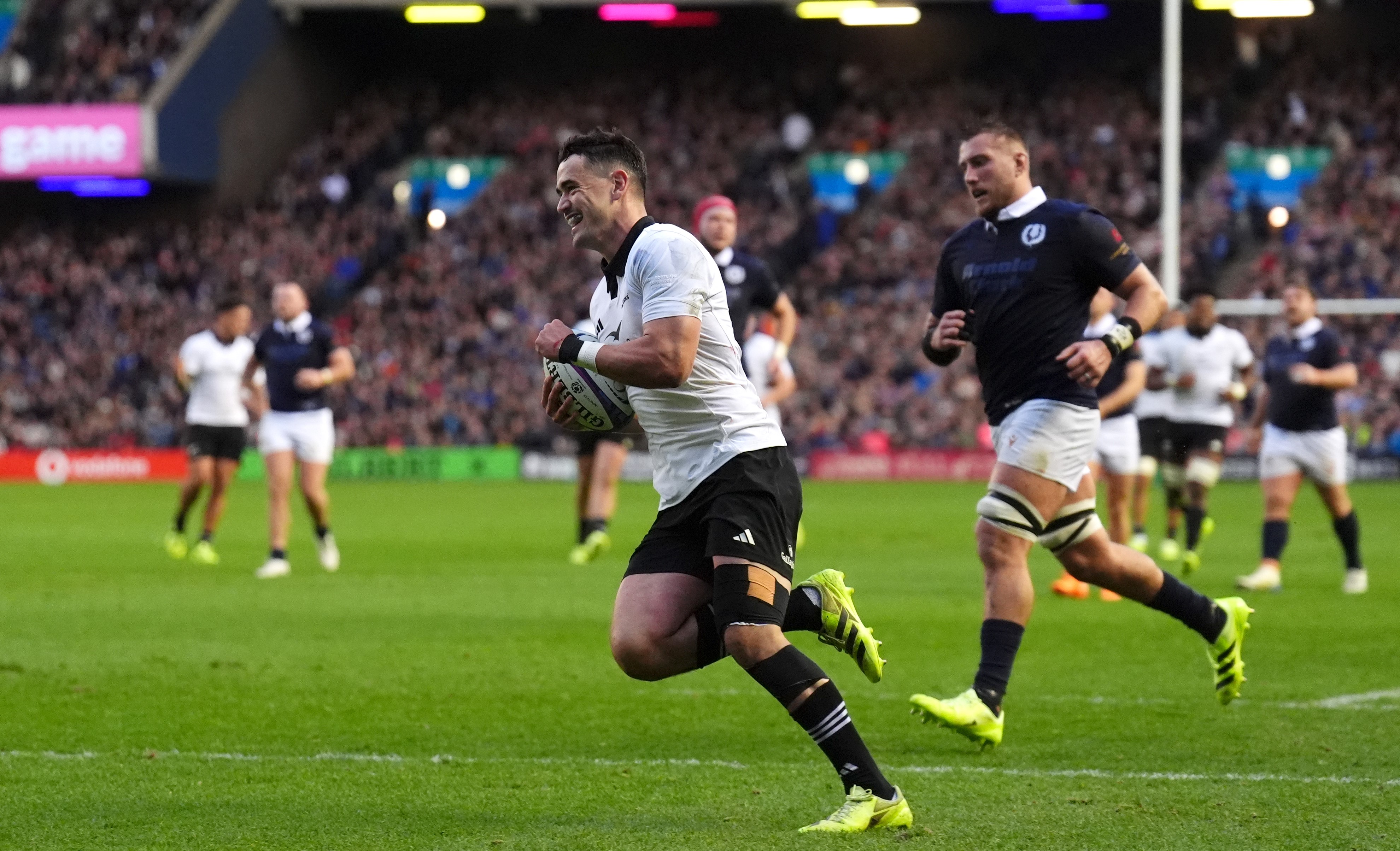 Will Jordan runs in for his try for the All Blacks just before halftime.