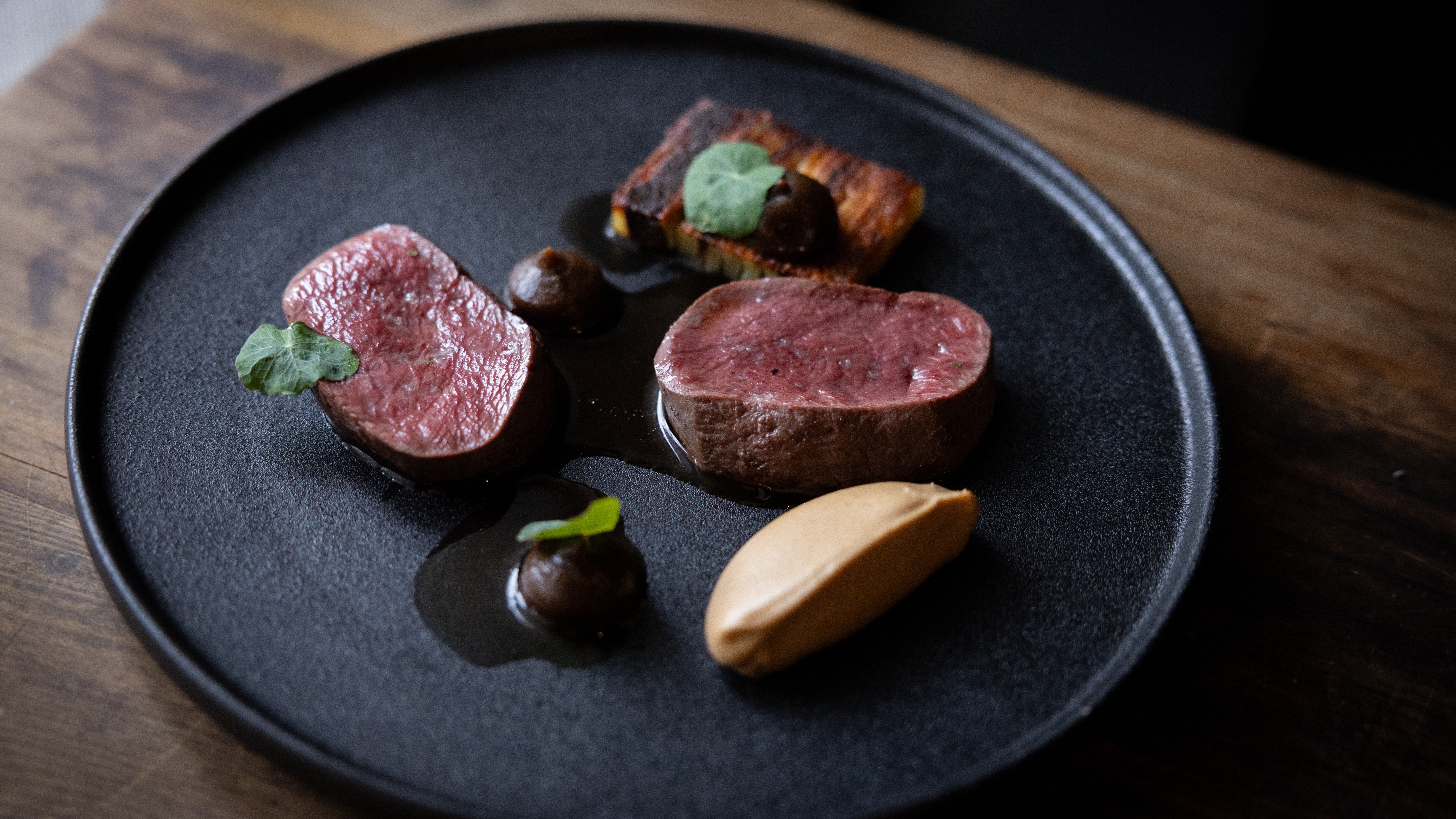 Rātā's Southland venison braised shank boulangère with celeriac and burnt apple.