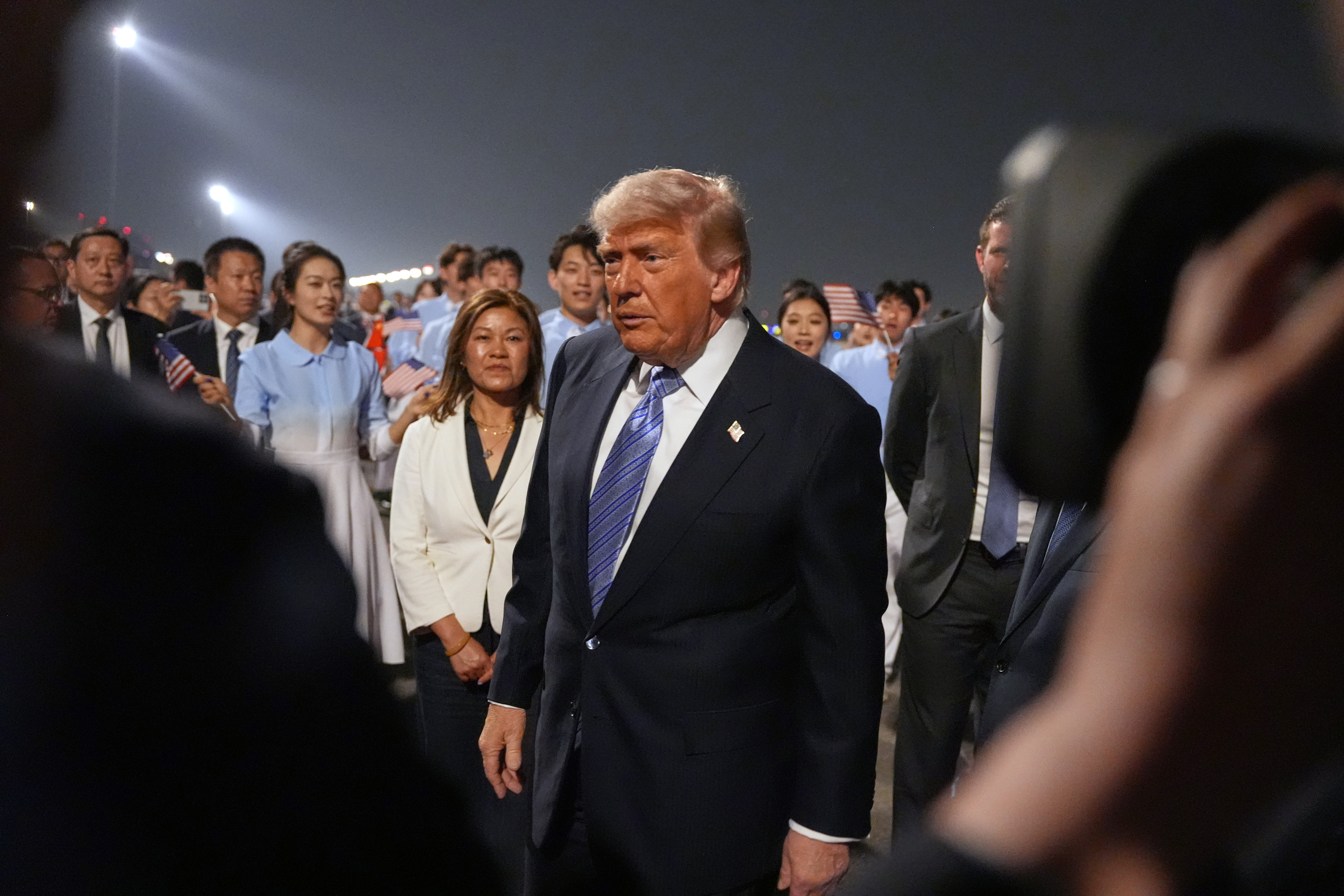 President Donald Trump walks during a welcome ceremony as he arrives on Air Force One, Wednesday, May 13 (local time), 2026, at Beijing Capital International Airport in Beijing.