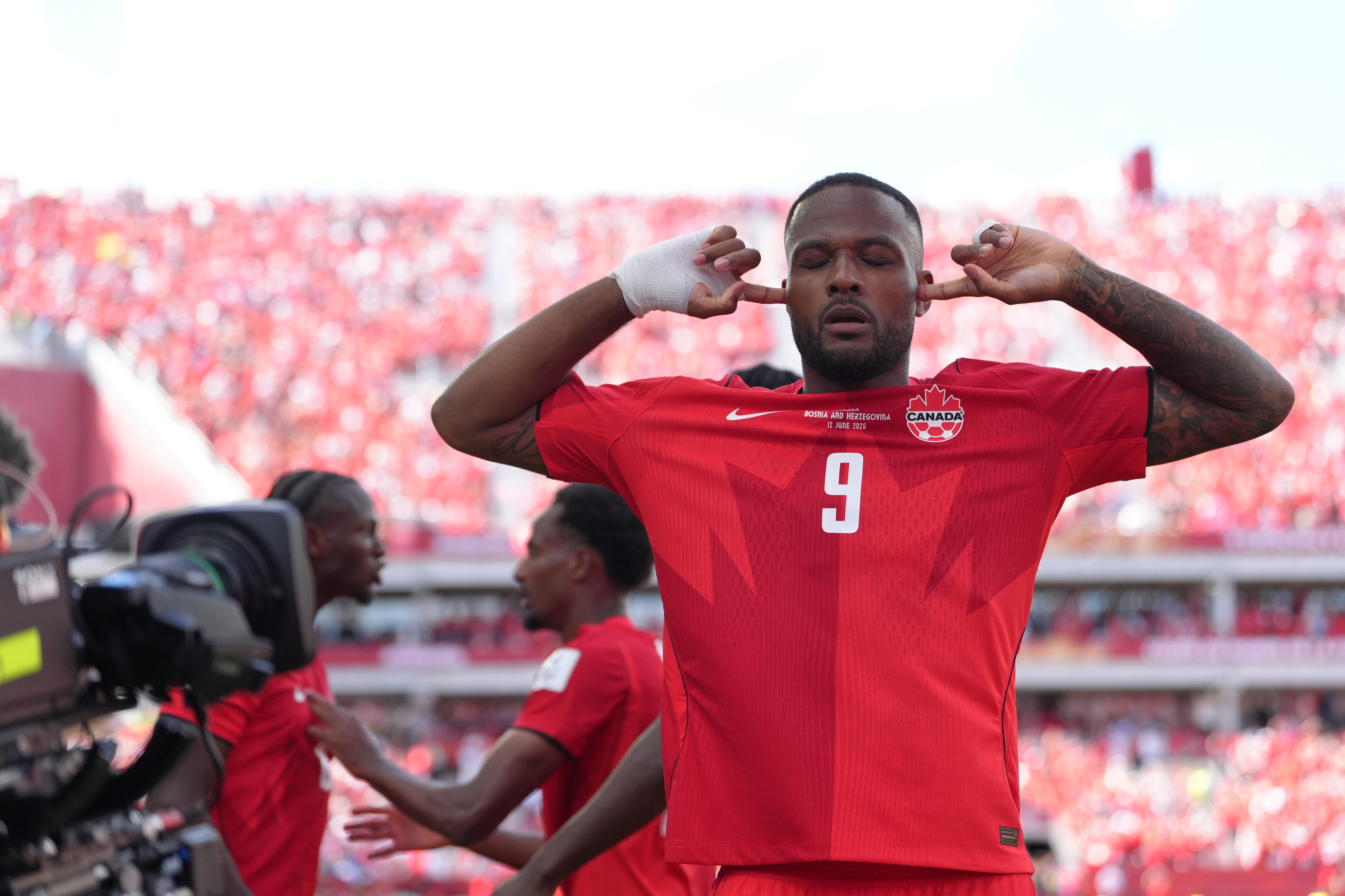 Canada's Cyle Larin (9) celebrates after scoring his sides first goal of the game in the second half of the World Cup Group B soccer match between Canada and Bosnia, Friday, June 12, 2026, in Toronto. 