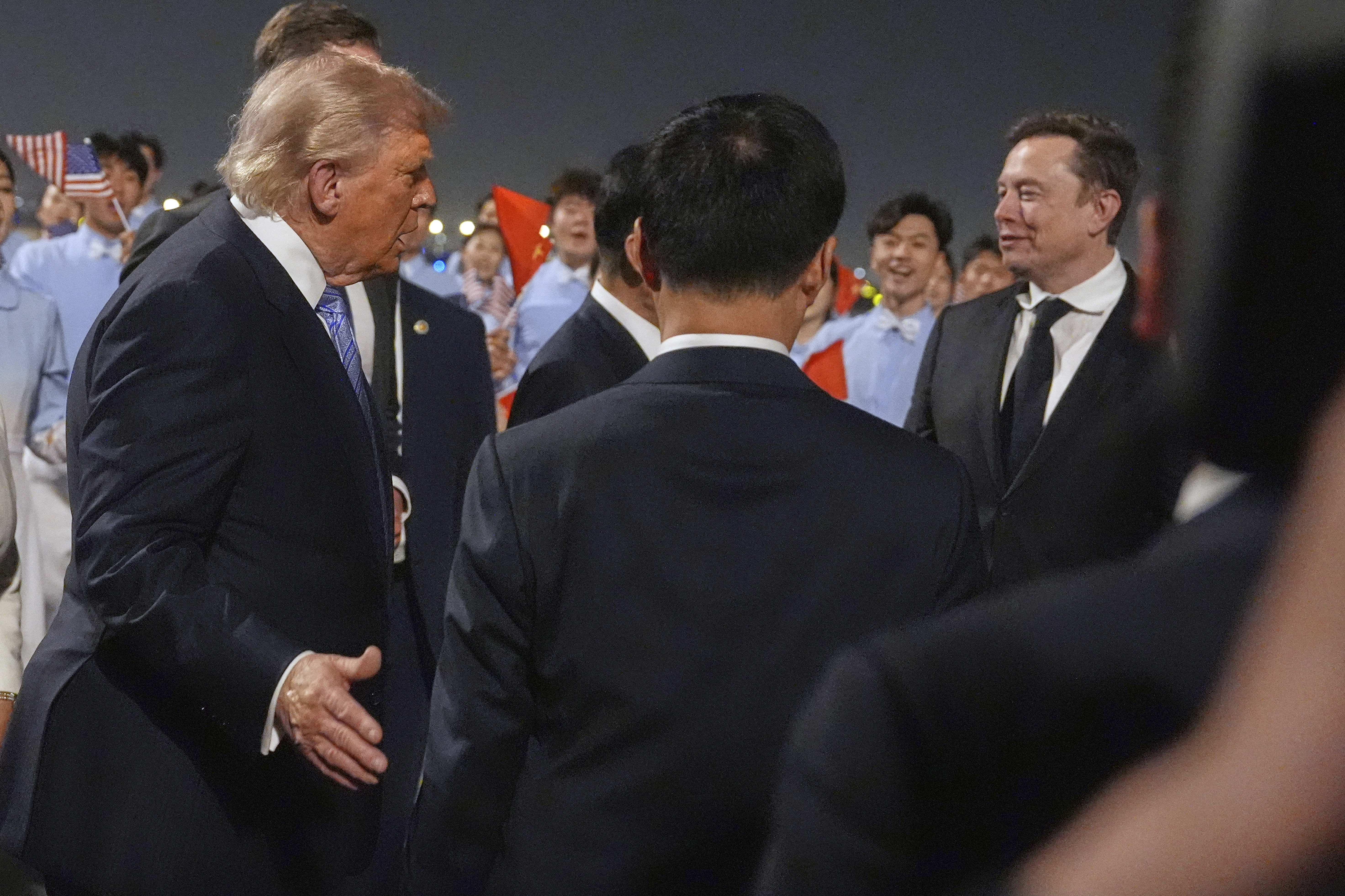 President Donald Trump talks with Elon Musk, right, during and arrival ceremony