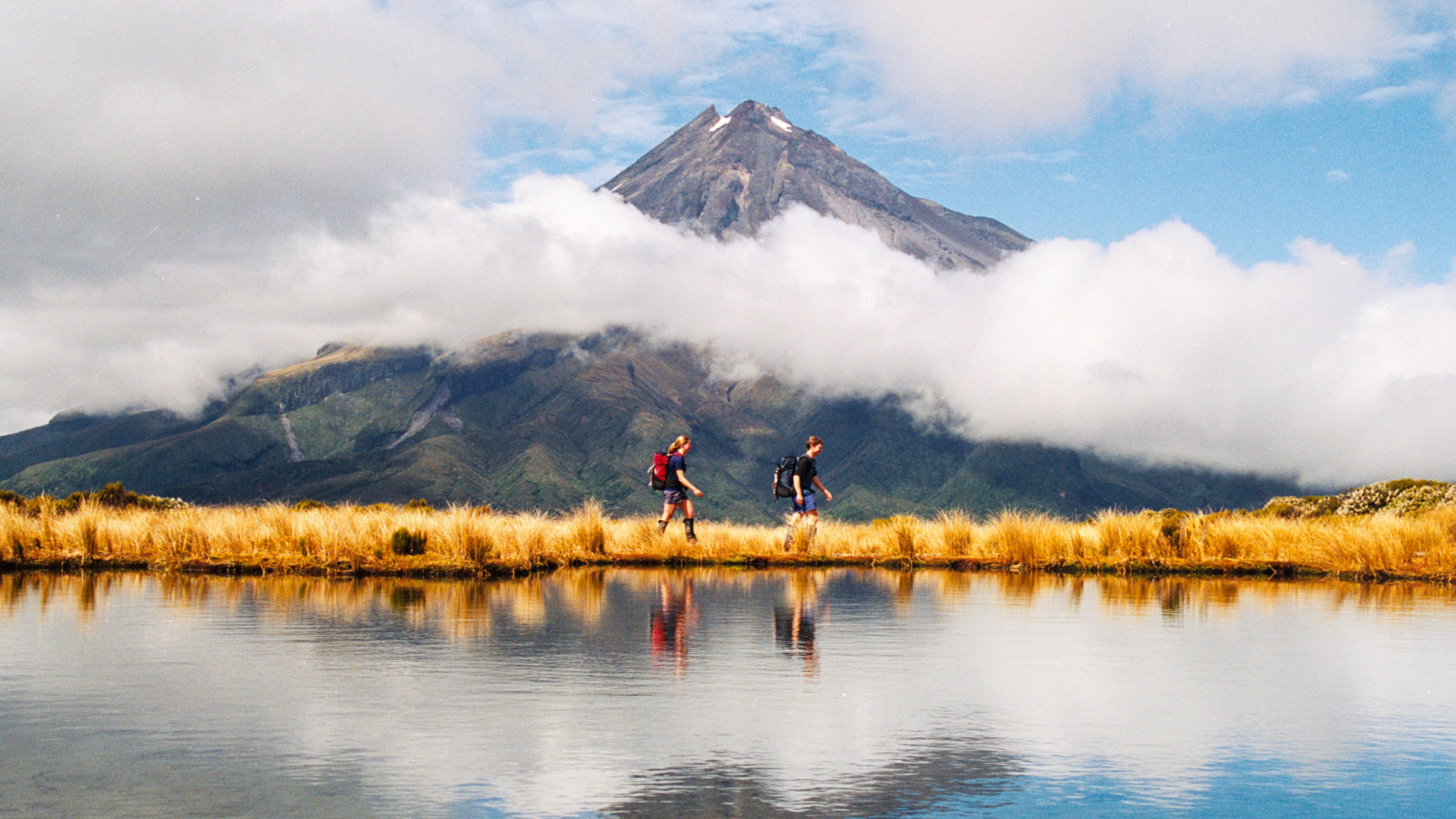 A file photo of Mount Taranaki with two hikers visible.