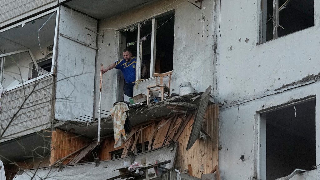 A man clears debris in his apartment building damaged after a Russian missile strike that hit in Kyiv, Ukraine, Tuesday, June 2, 2026.