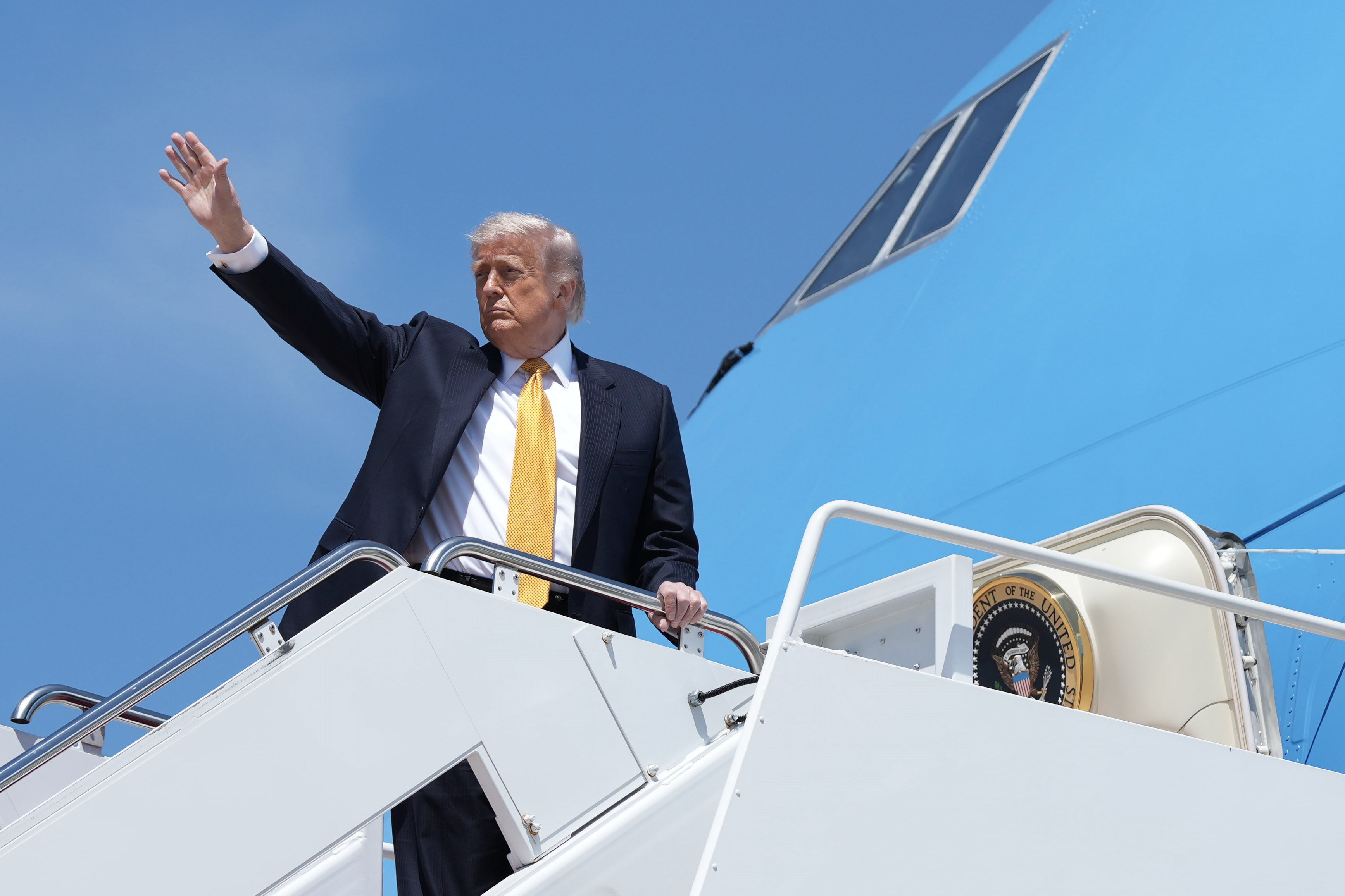 President Donald Trump boards Air Force One for a trip to China. 