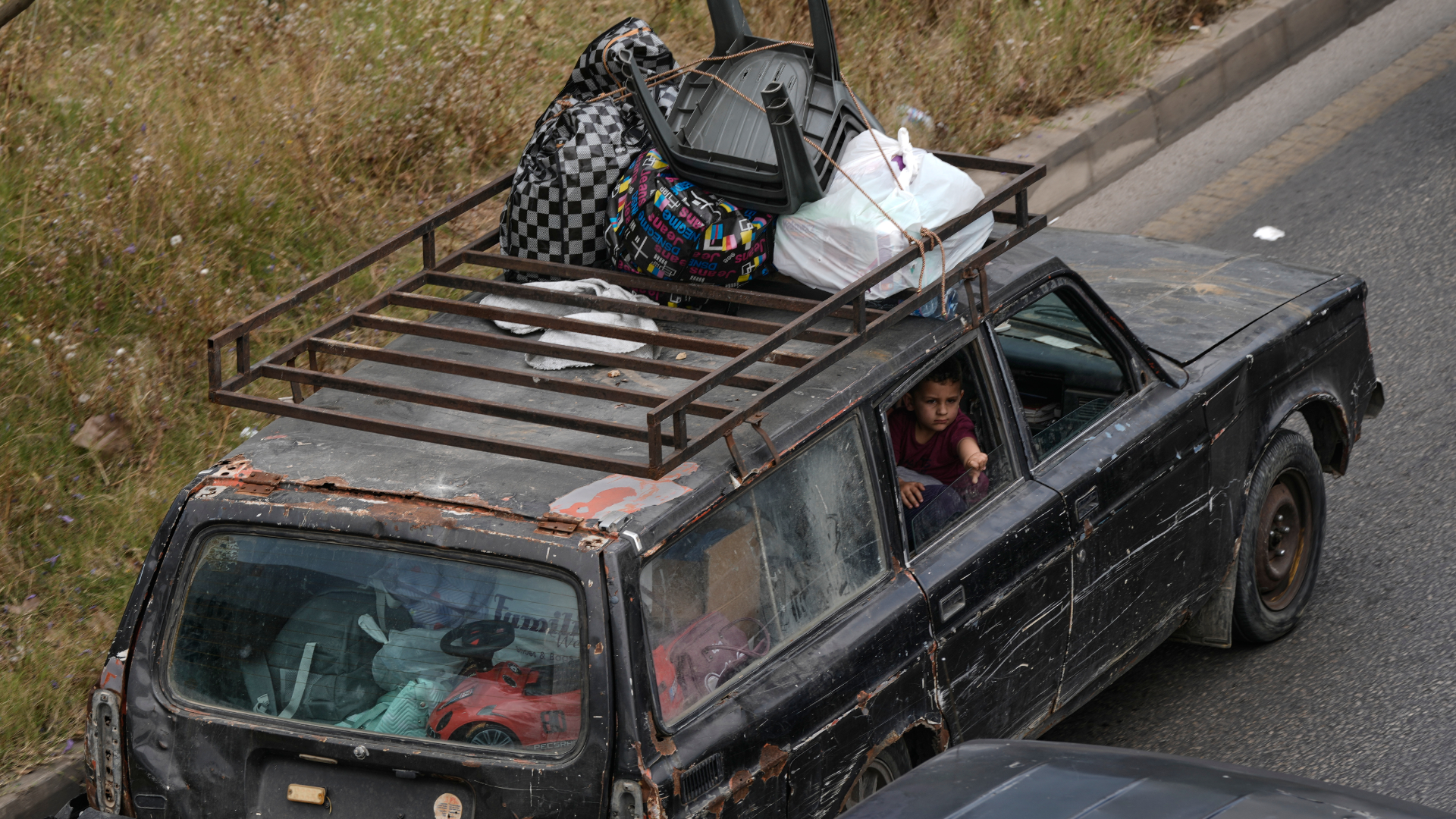 A family flees following an Israeli threat to strike Dahiyeh, Beirut's southern suburbs.
