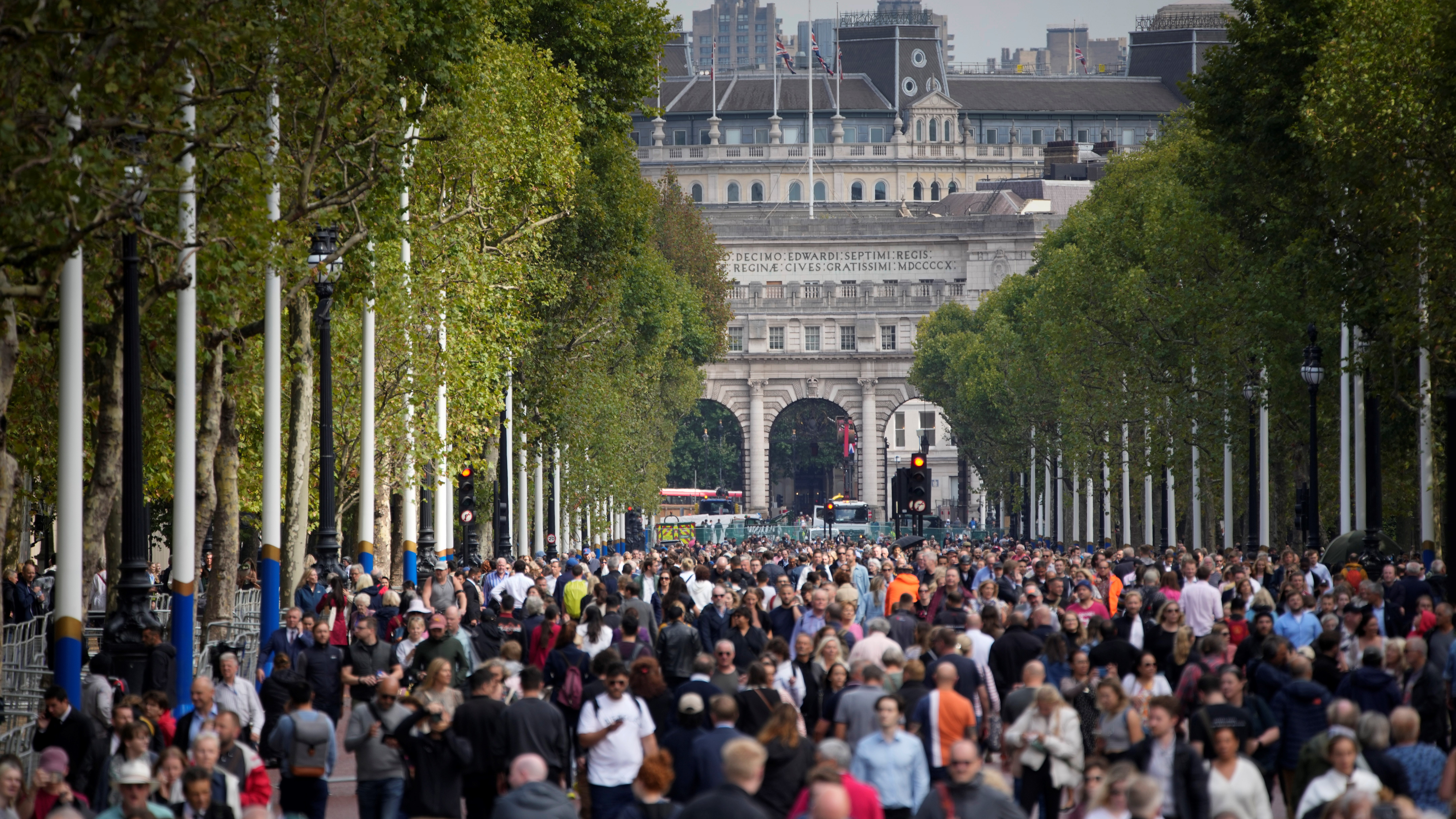 Mourners walk down the mall outside Buckingham Palace.
