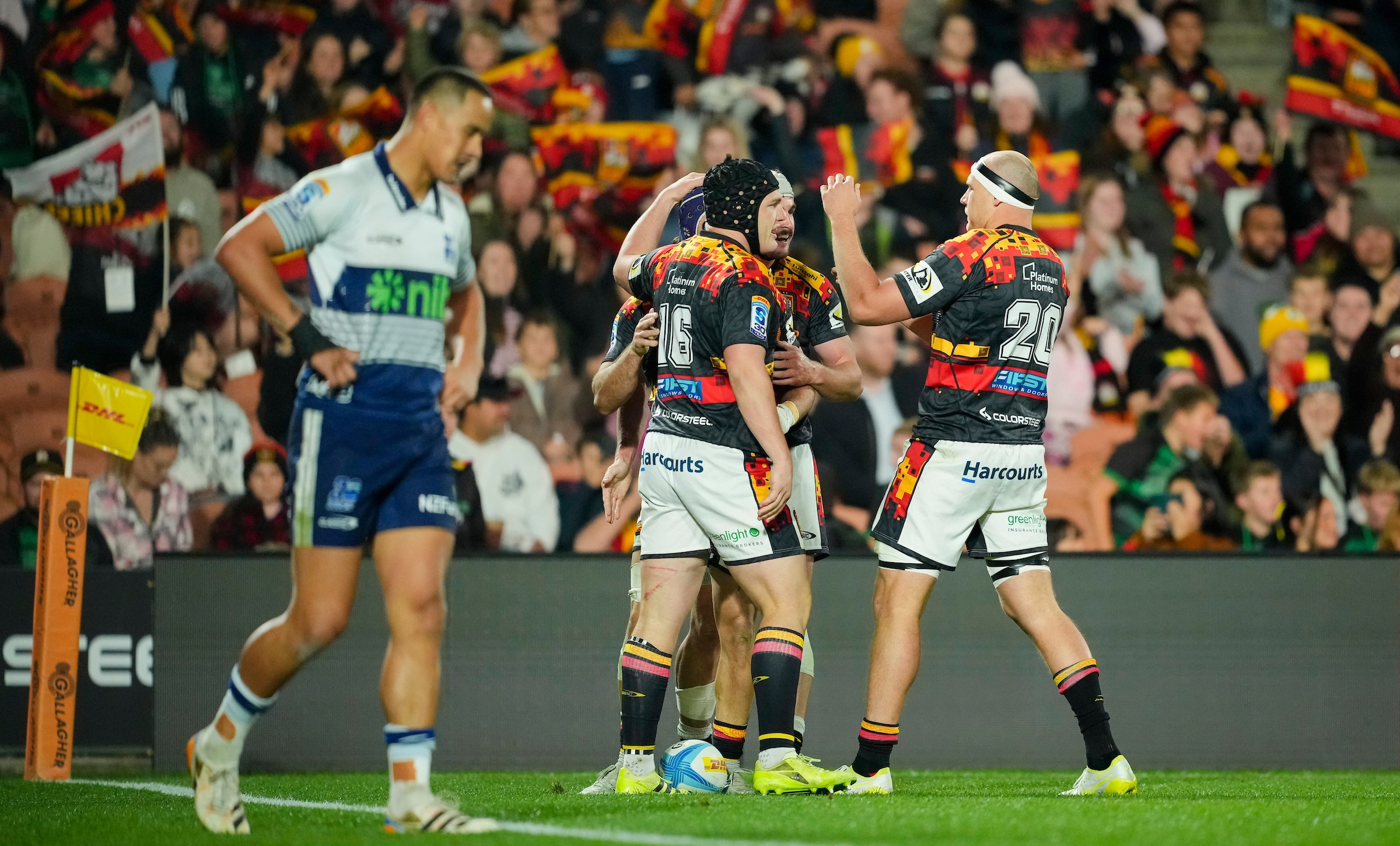 The Chiefs celebrate a try during their final round victory over the Blues in Hamilton in front of a dejected looking Zarn Sullivan.